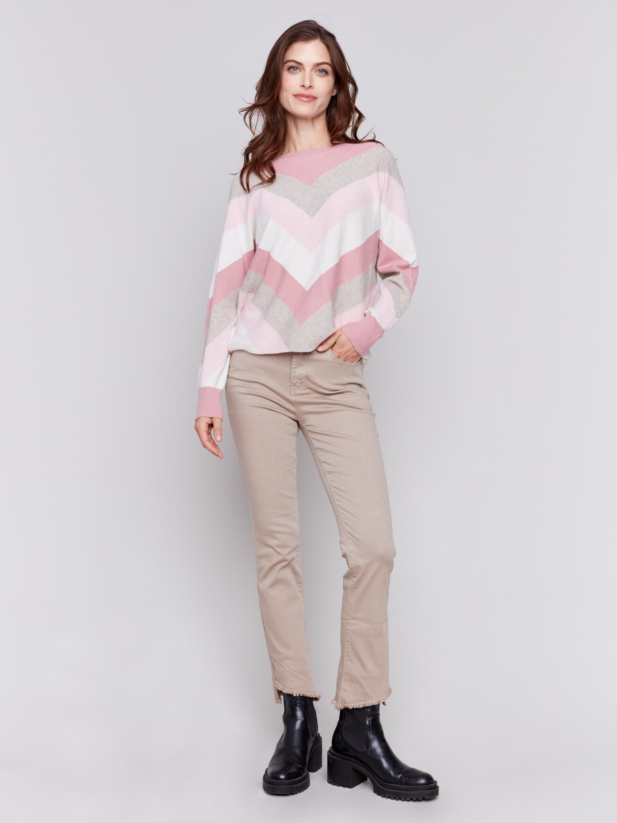 Woodrose-colored long-sleeve sweater with chevron stripes in pink, white, and beige. Crew neckline and ribbed cuffs by Charlie B.