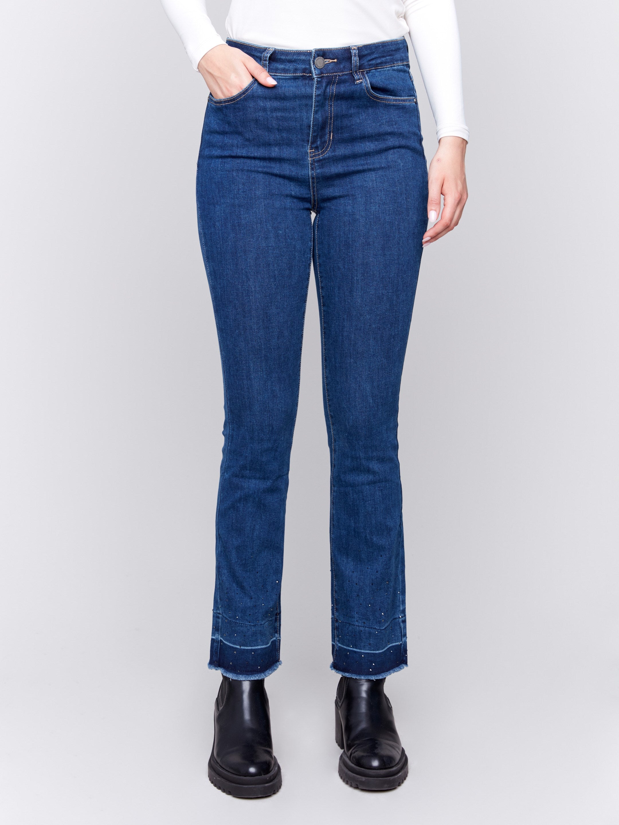 Indigo blueflare jeans with ombre hem and stud details, featuring five-pocket design and regular rise by Charlie B.