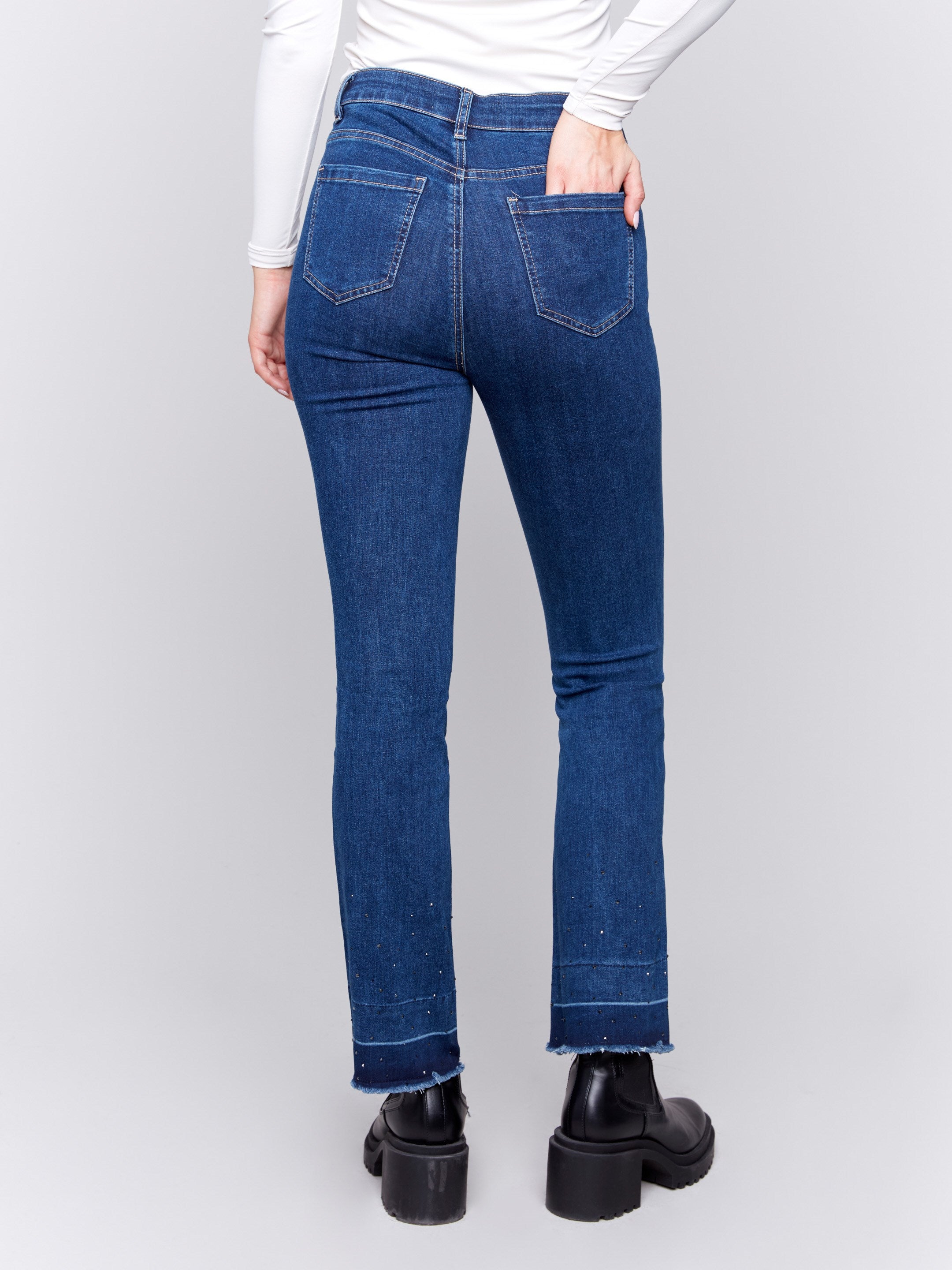 Indigo blueflare jeans with ombre hem and stud details, featuring five-pocket design and regular rise by Charlie B.