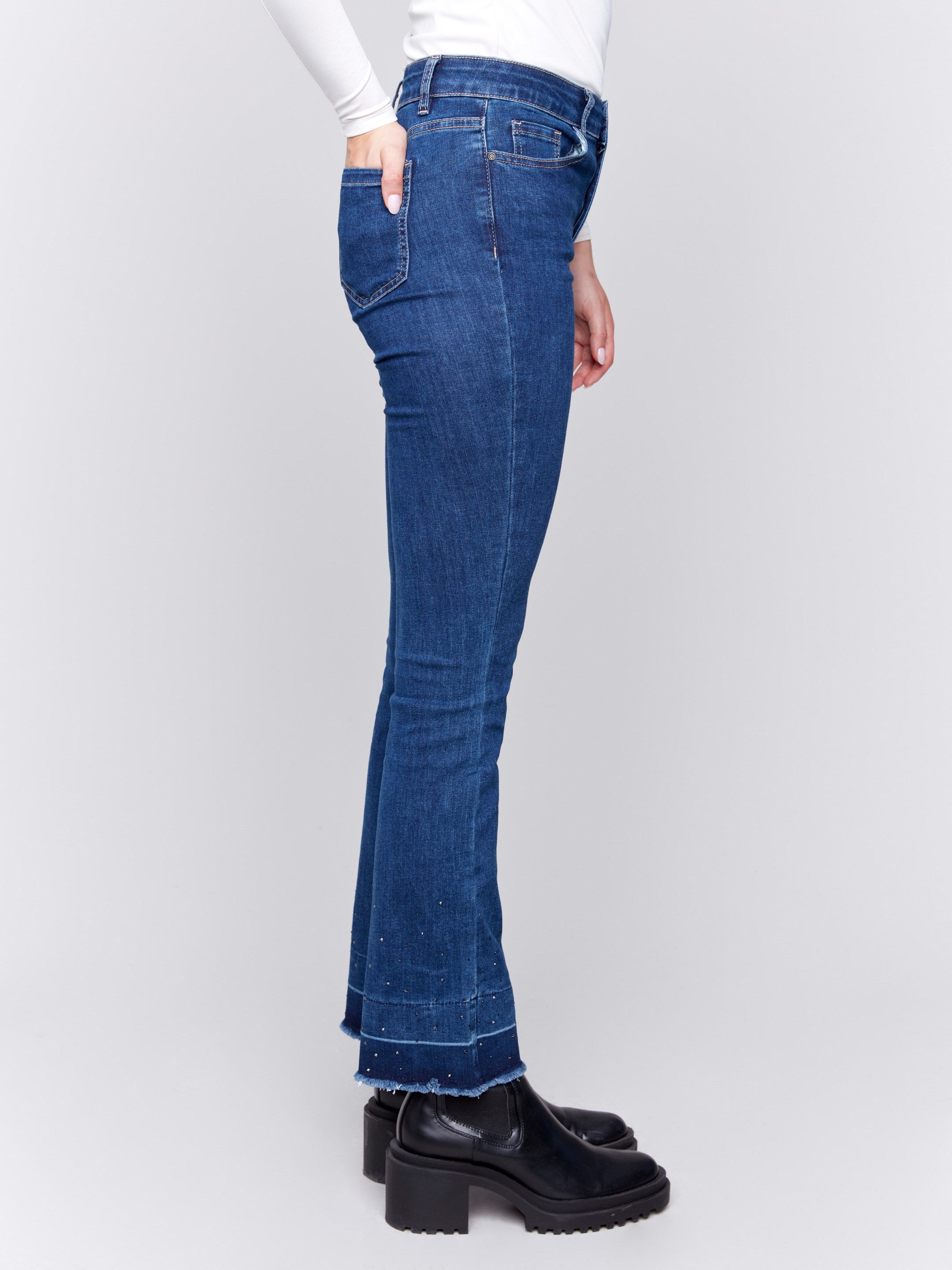 Indigo blueflare jeans with ombre hem and stud details, featuring five-pocket design and regular rise by Charlie B.