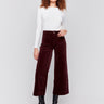 Plum purple corduroy flare pants with front and back patch pockets, a regular rise, and cropped design by Charlie B.