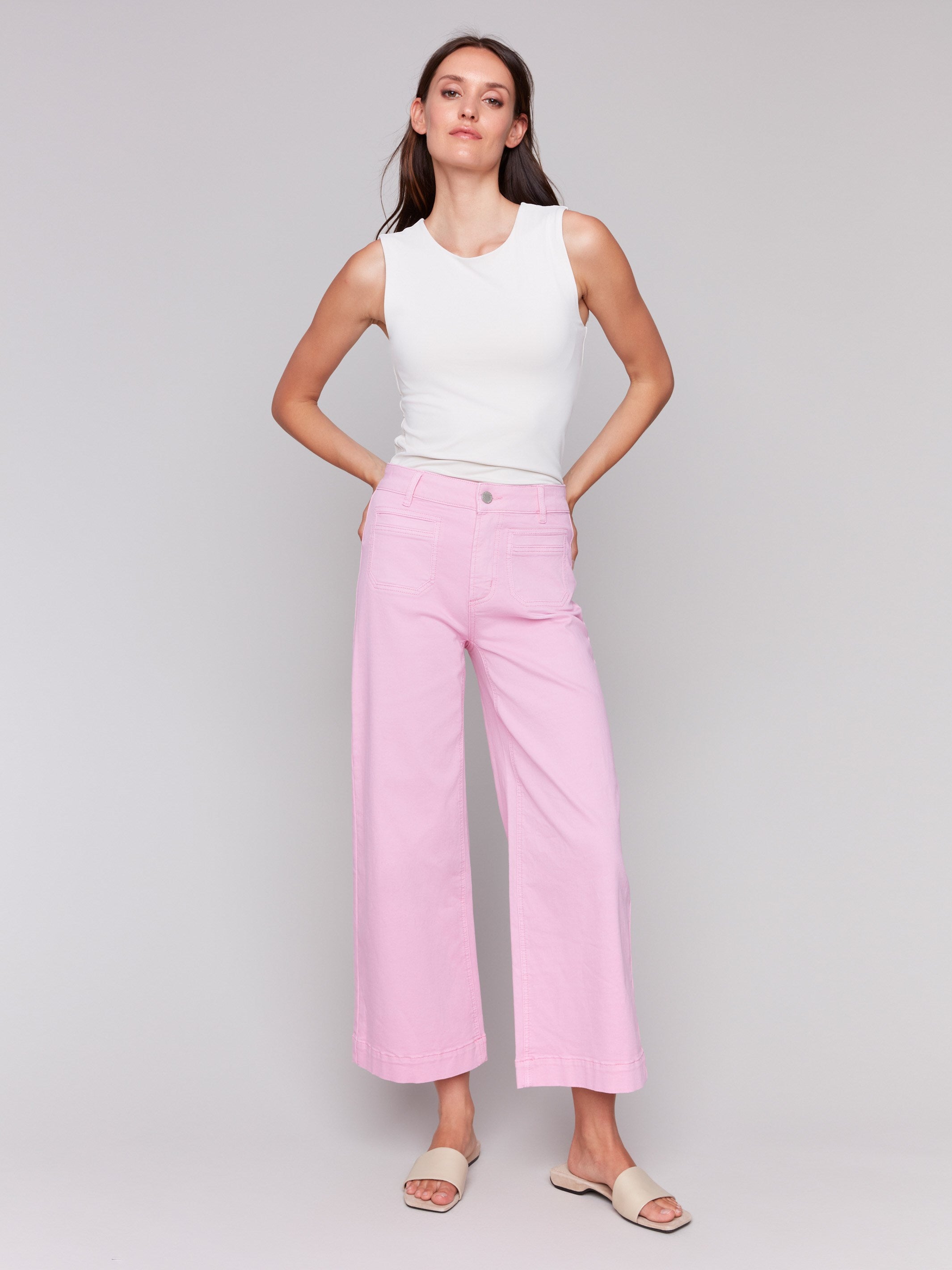 Begonia flare twill pants featuring front patch pockets with a regular rise, button closure by Charlie B.