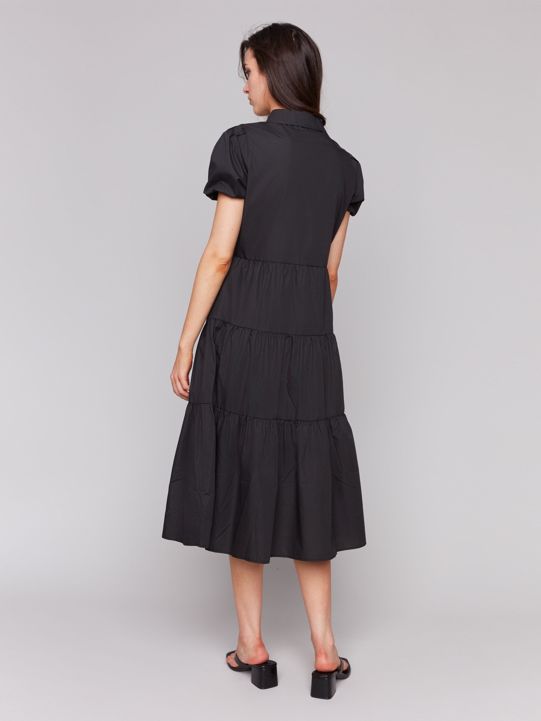 Chic black dress showcasing short puff sleeves by Charlie B.