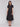 Sophisticated black midi dress with tiered design by Charlie B.