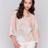 V-neck floral blouse with decorative buttons by Charlie B.