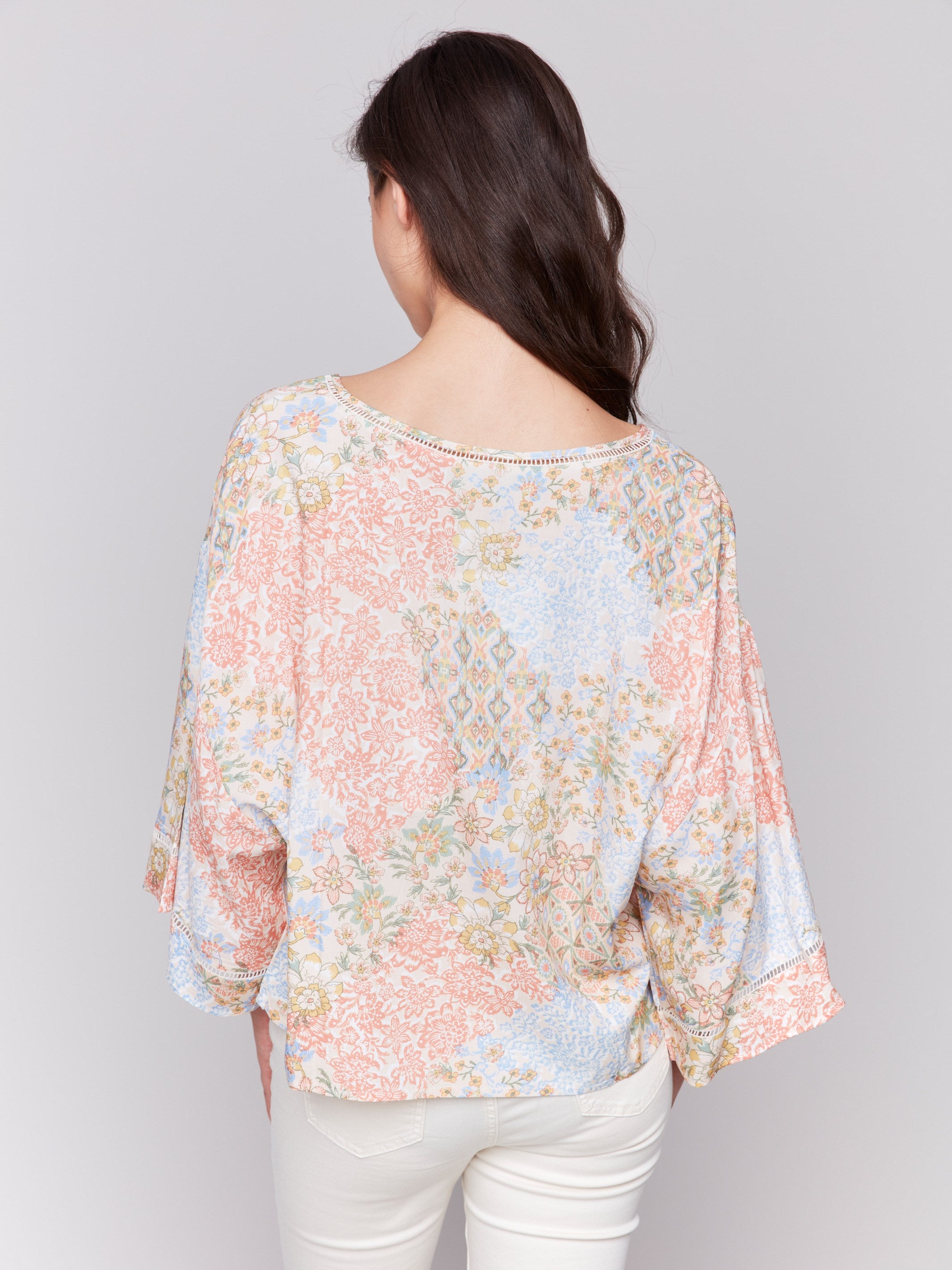 Floral blouse showcasing V-neck and abstract pattern by Charlie B.