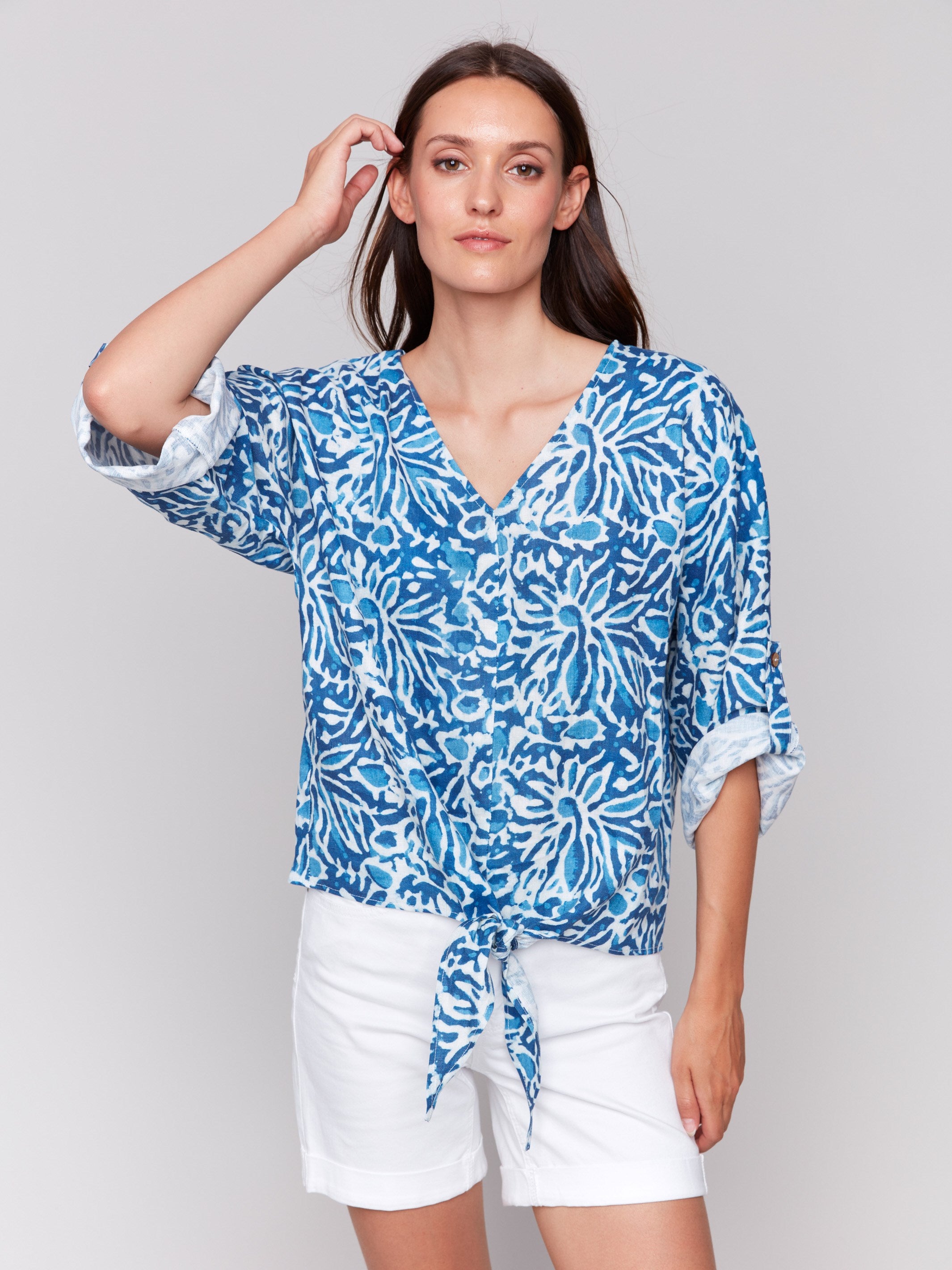 3/4 sleeve top with front tie knot at hem, showcasing abstract design by Charlie B.