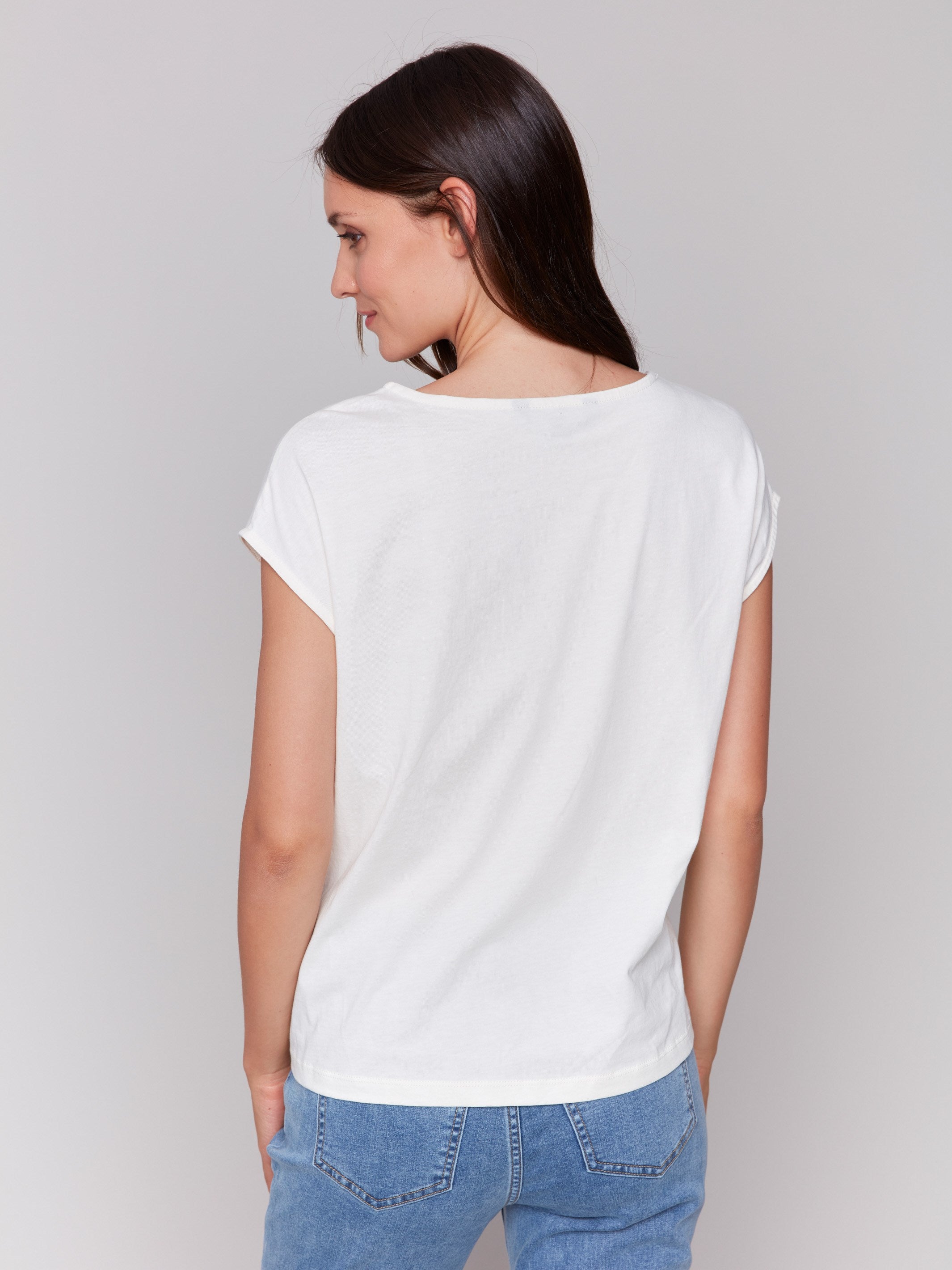 White sleeveless top with colorful 'LOVE' graphic print and a front-knot design by Charlie B.