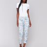 Blue and white jogger pants with a relaxed fit and floral print by Charlie B.