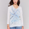 White sweater with indigo tie-dye pattern, featuring a v-neck and dolman sleeves by Charlie B.