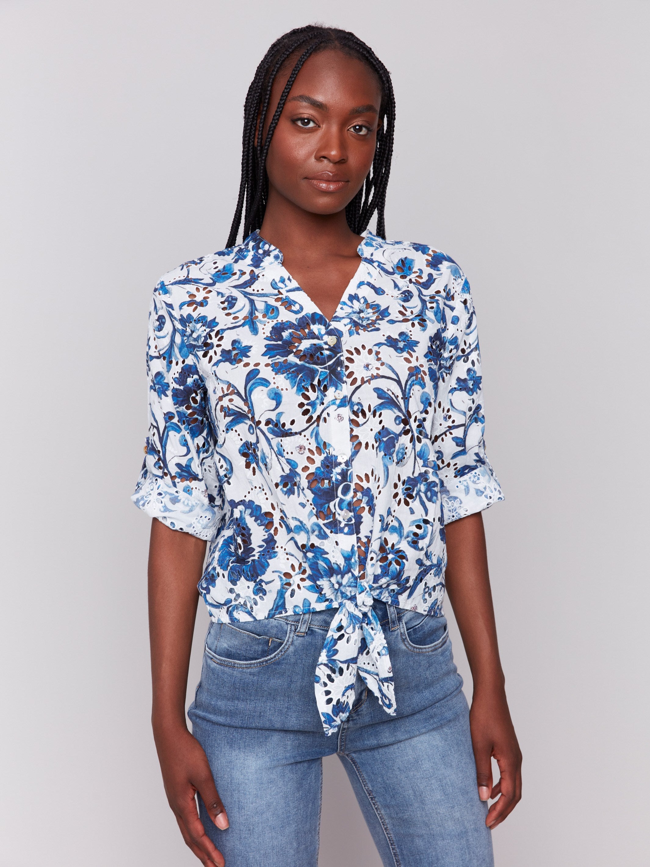 Blue blouse with a V-neckline and floral pattern by Charlie B.