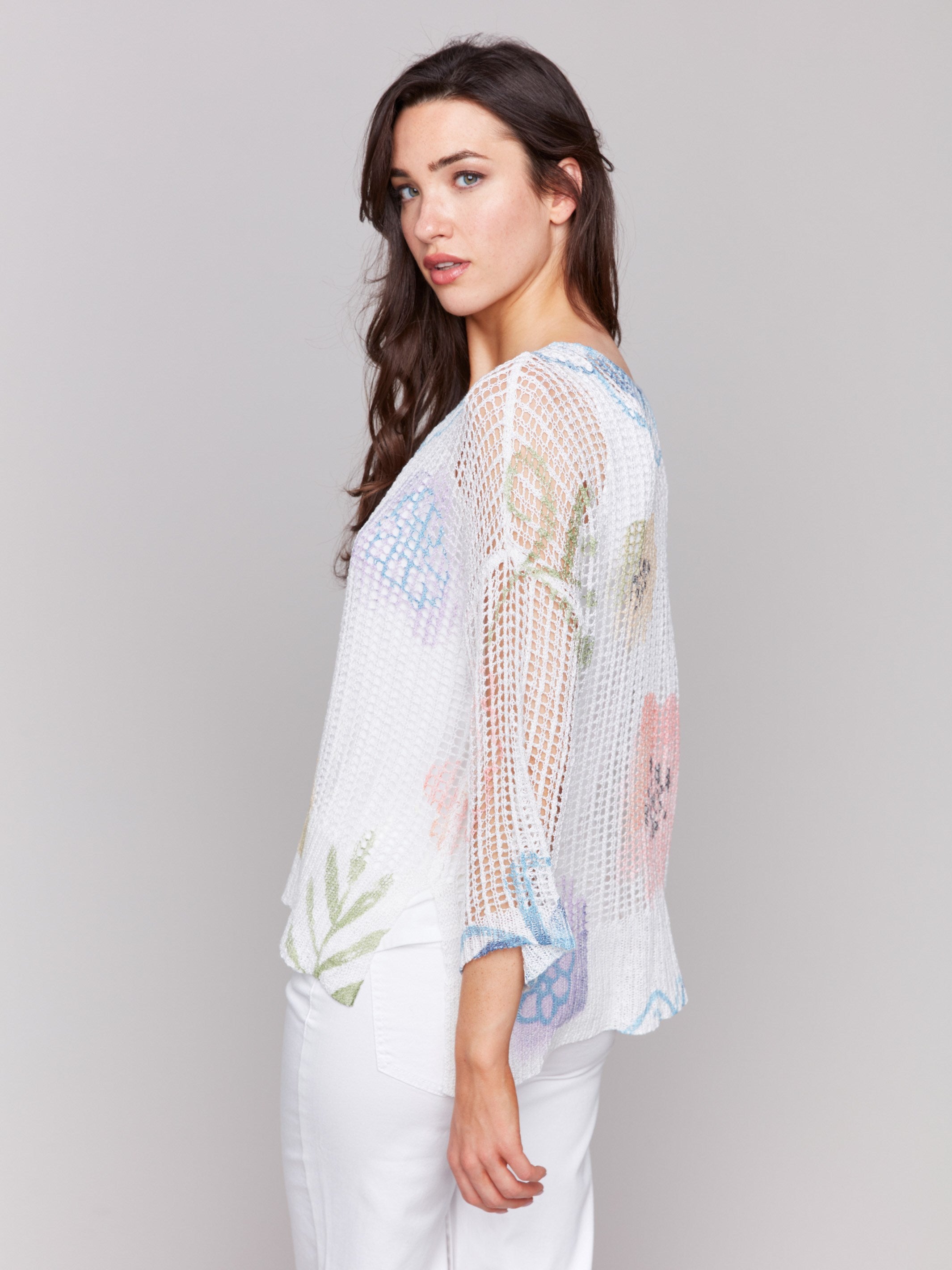 A lightweight V-neck crochet sweater with a watercolor print and loose fit by Charlie B.