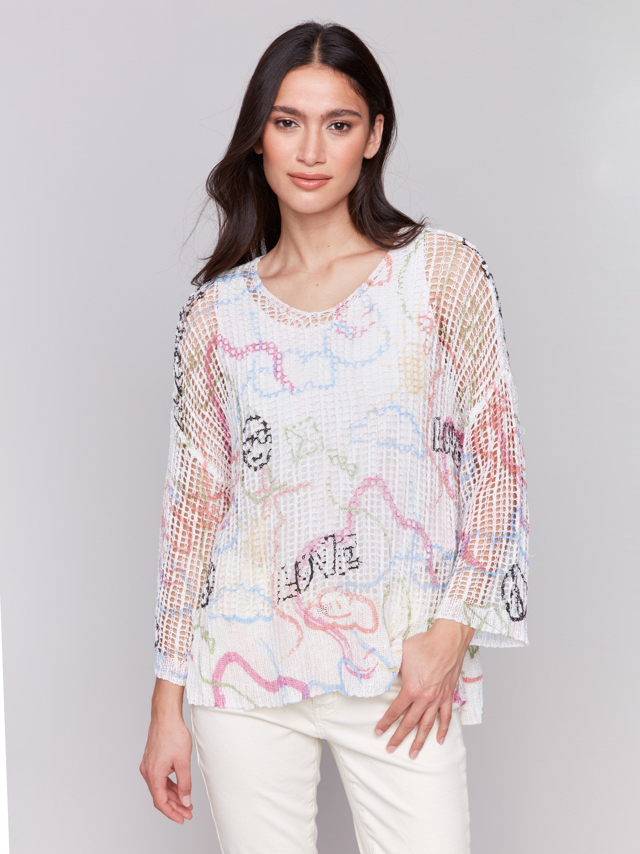 A lightweight V-neck crochet sweater with a graffiti print and loose fit by Charlie B.