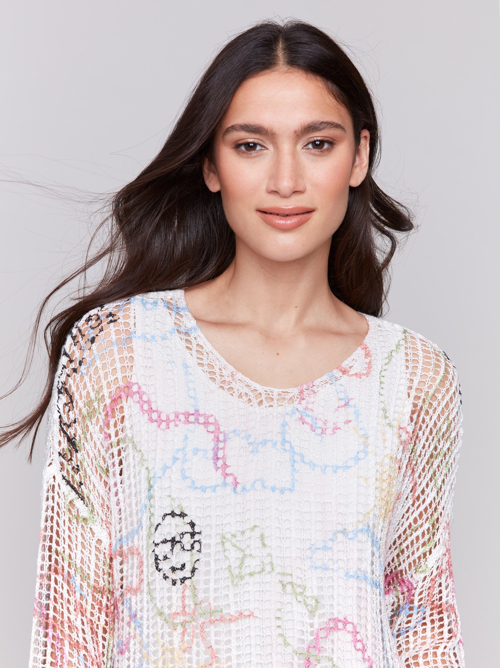 A lightweight V-neck crochet sweater with a graffiti print and loose fit by Charlie B.