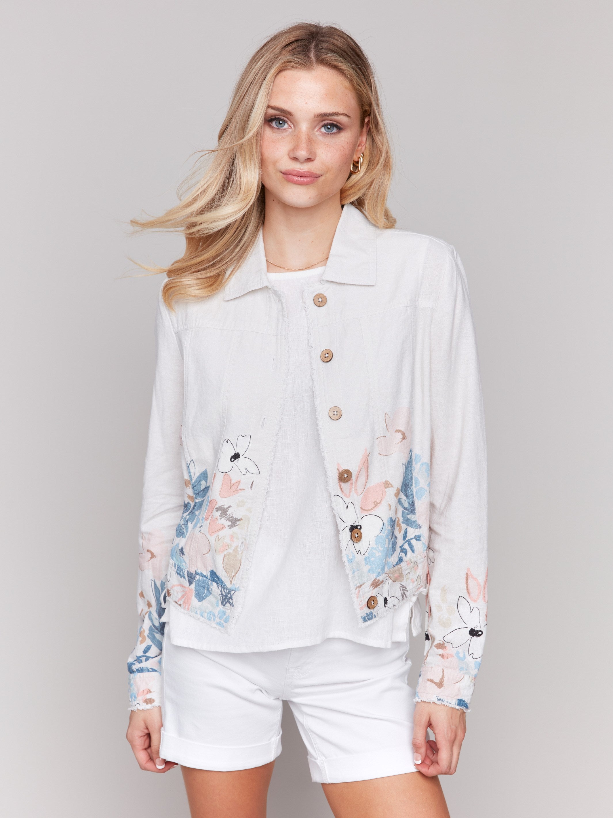 White jacket with a shirt collar and multicolor floral border print by Charlie B.