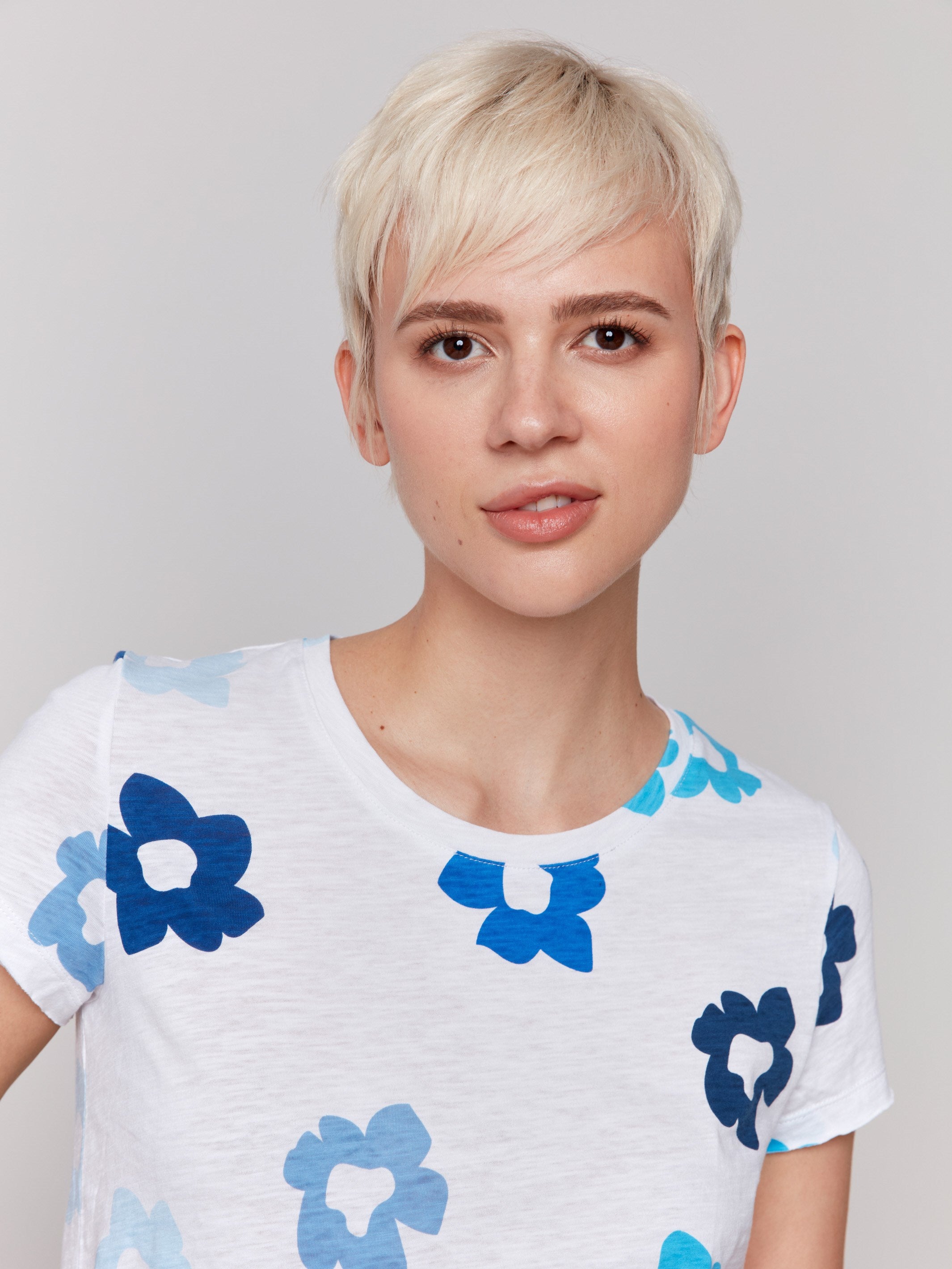 Organic cotton t-shirt featuring a vibrant blue floral design by Charlie B.