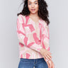 Raspberry pink V-neck sweater with an abstract print and drop shoulders by Charlie B.