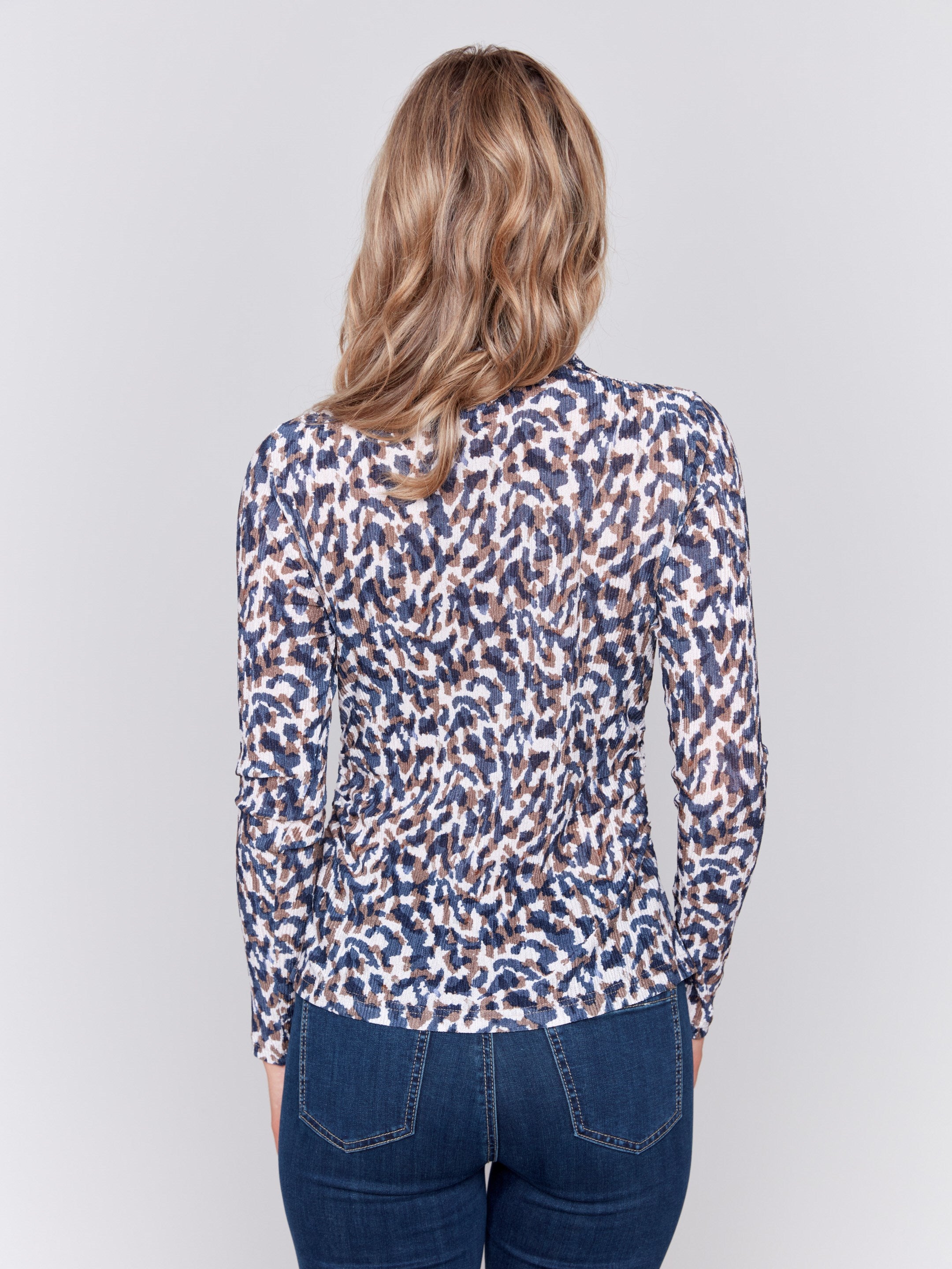 Long sleeve mock neck top with a safari print by Charlie B.