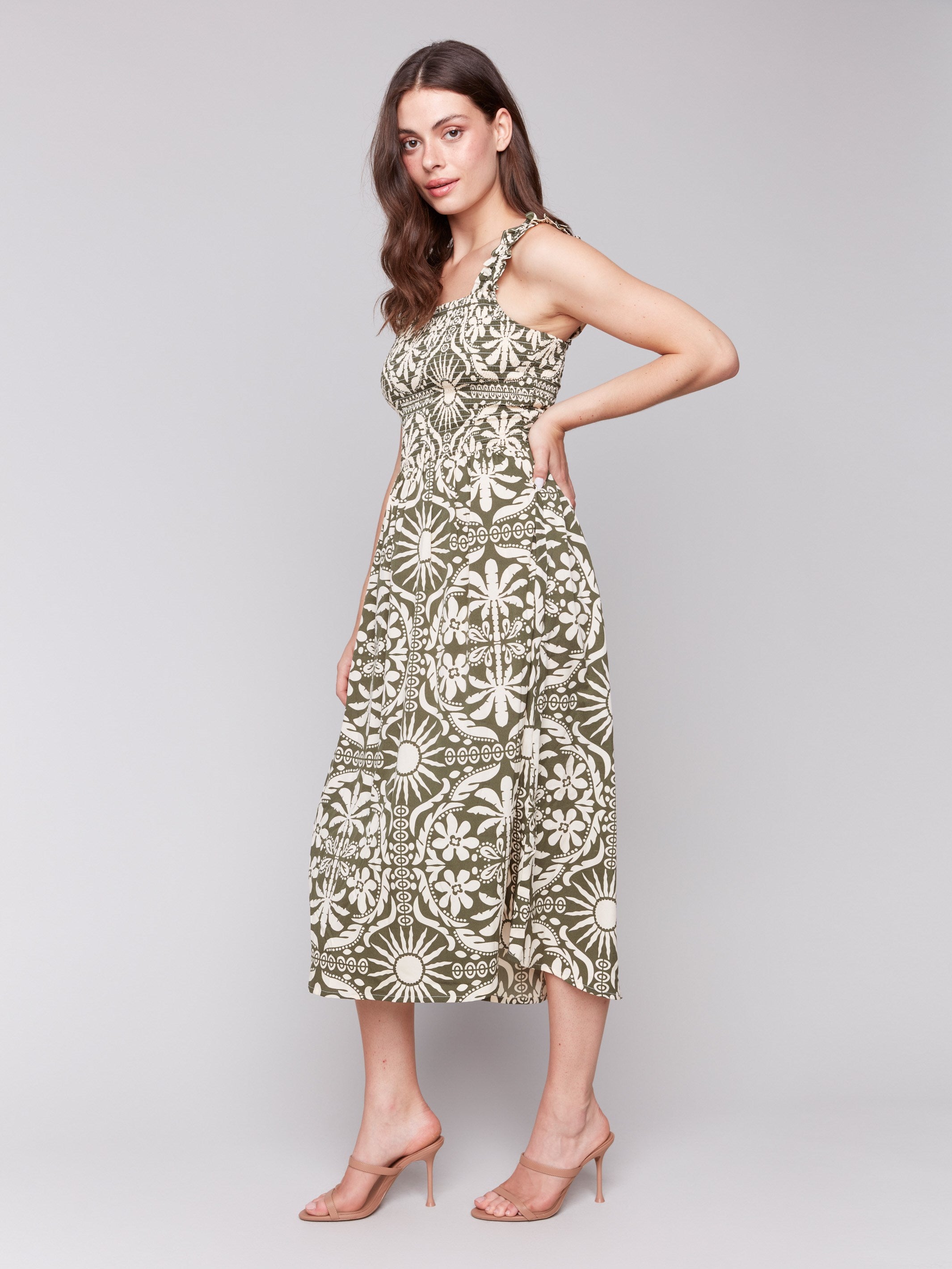 Artistic print in a sleeveless design on this celadon-green midi dress by Charlie B.