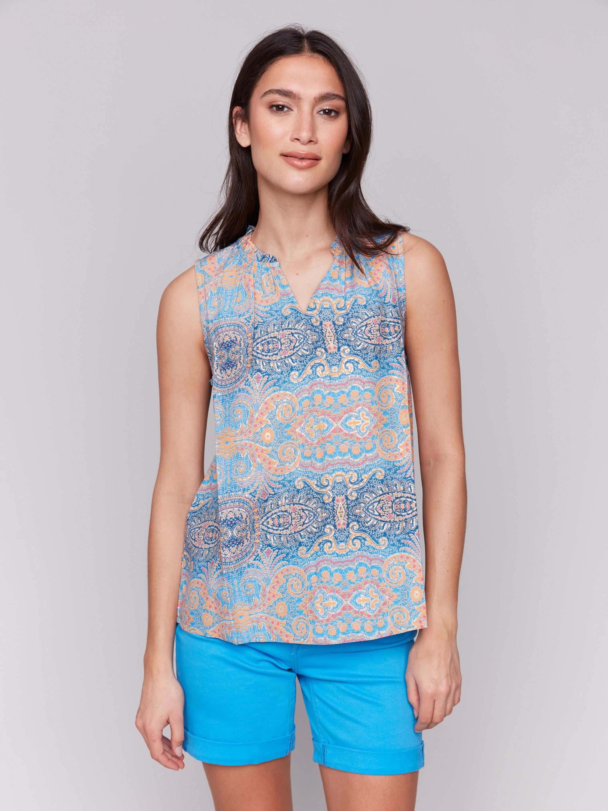 Blue and orange blouse featuring an intricate abstract pattern by Charlie B.