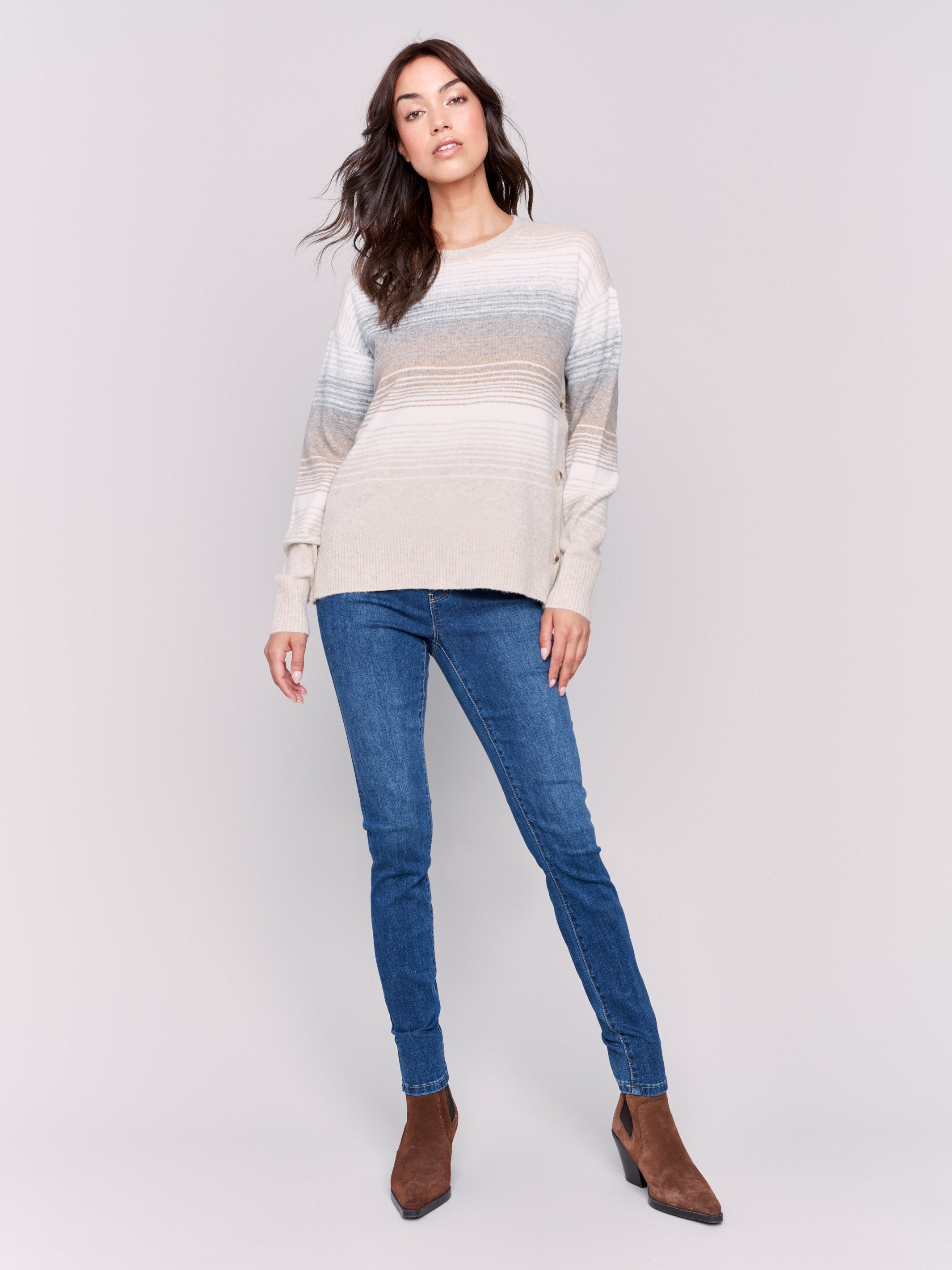 Striped sweater with long sleeves and side buttons, featuring a cozy and chic design by Charlie B.