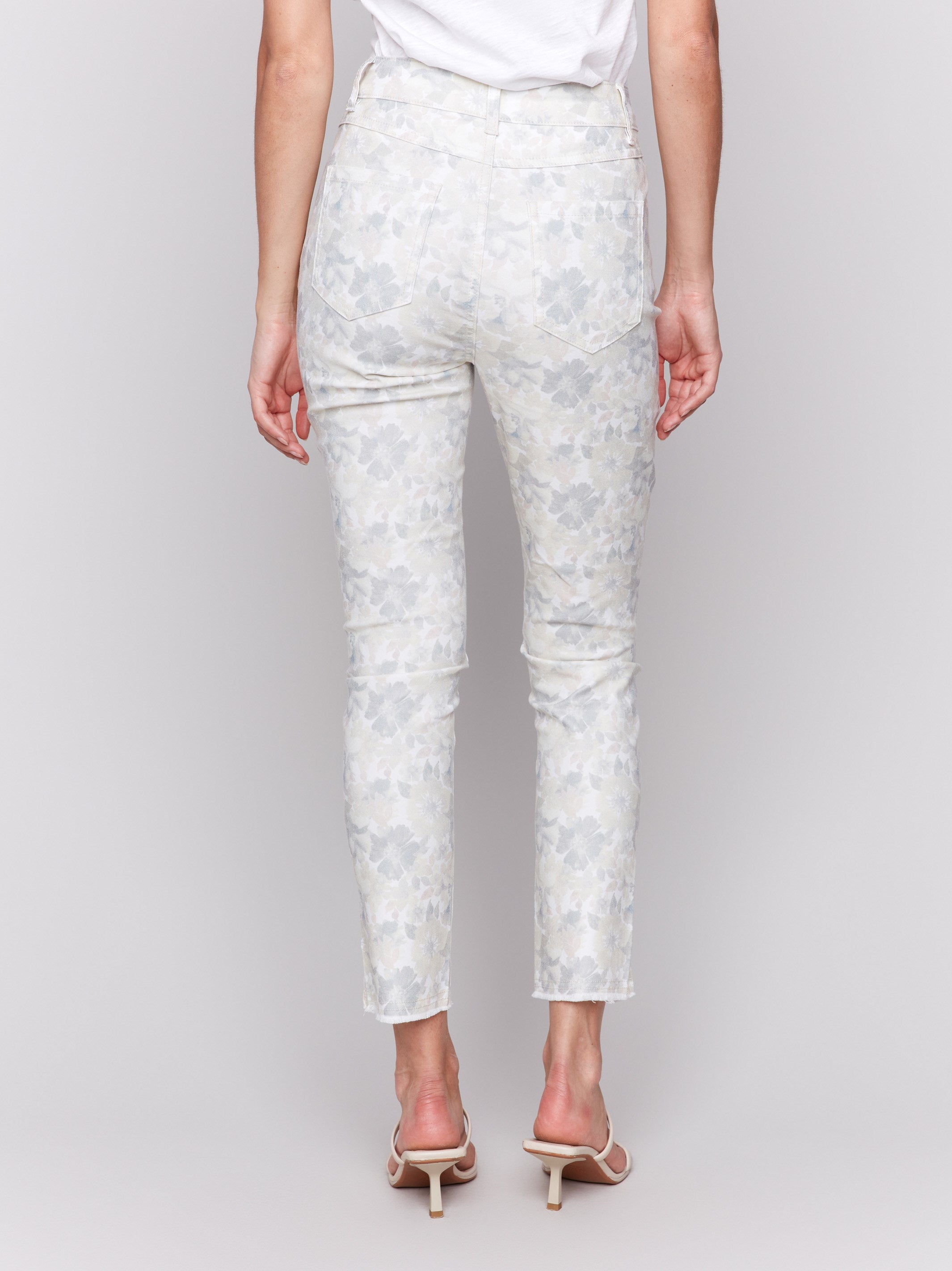 Slim-fit pants showcasing hem slit detail and floral pattern by Charlie B.