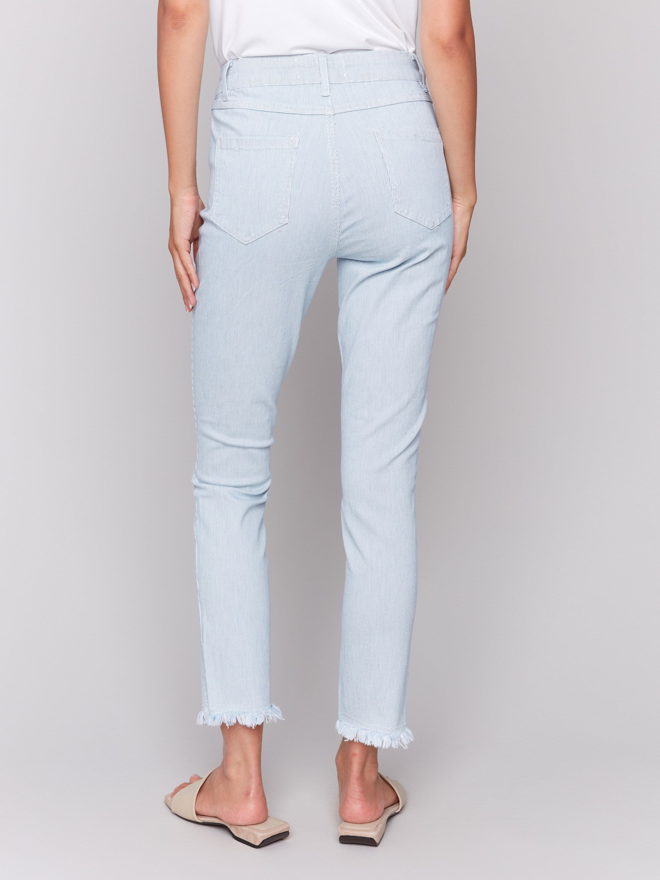 Light blue twill pants with subtle stripe pattern, featuring a slim leg silhouette and a slit at the hem by Charlie B.