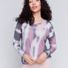 Long-sleeve V-neck knit top with a unique tie-dye print by Charlie B.