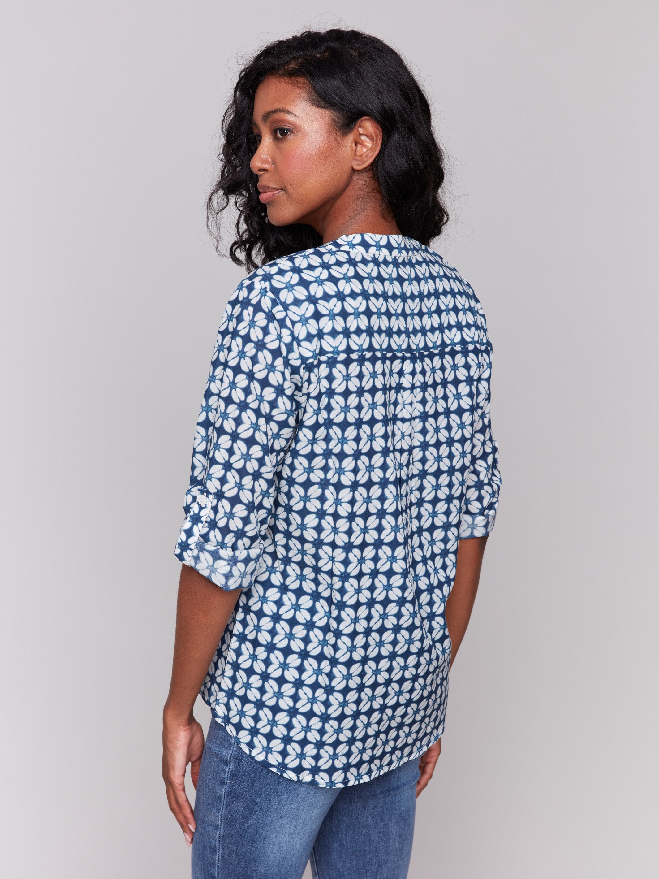 Chic blue geometric patterned blouse, highlighted by its adjustable roll-up sleeves and chest pocket by Charlie B.