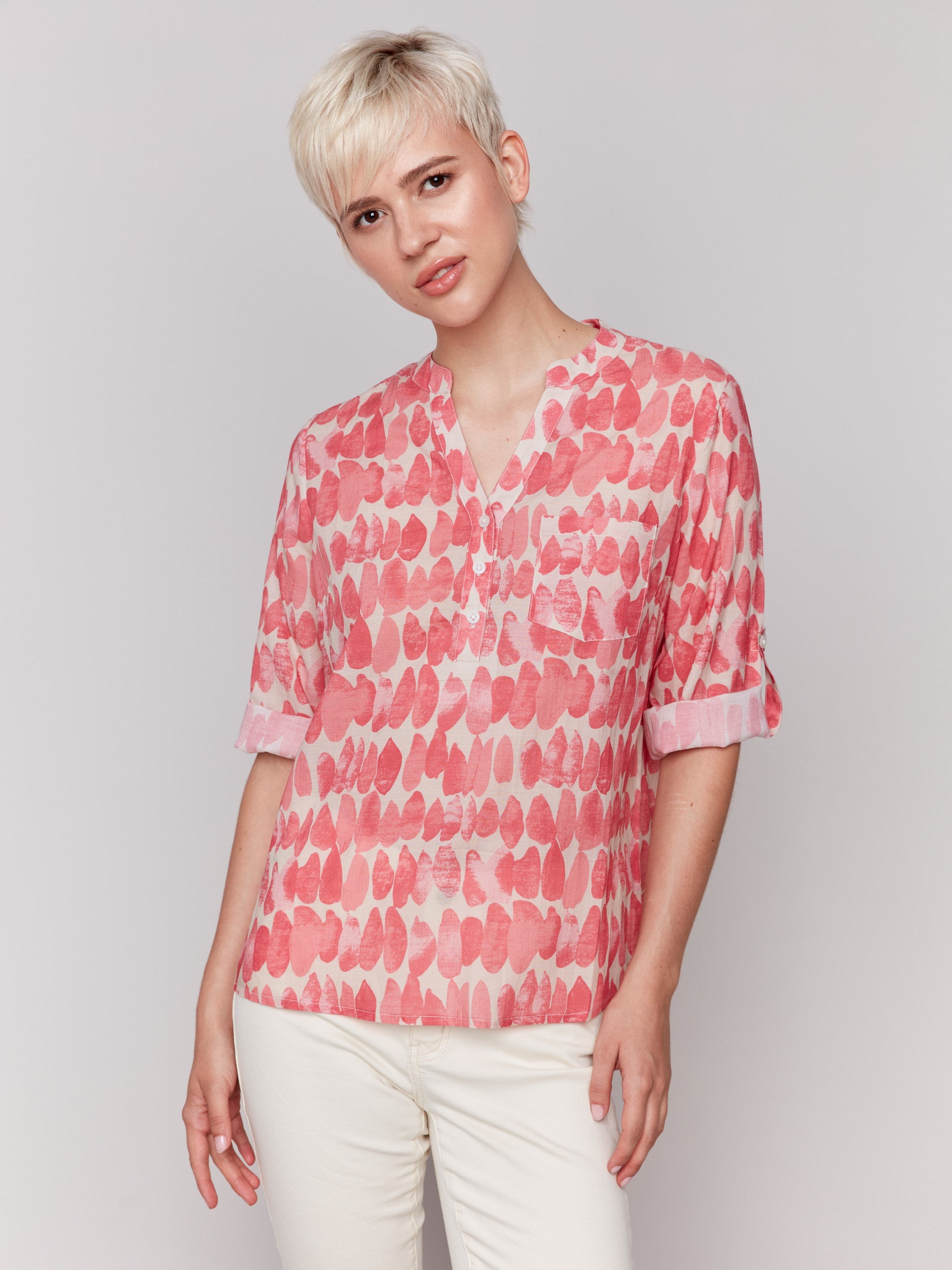 Red and white blouse with adjustable roll-up sleeves, featuring an abstract pattern by Charlie B.