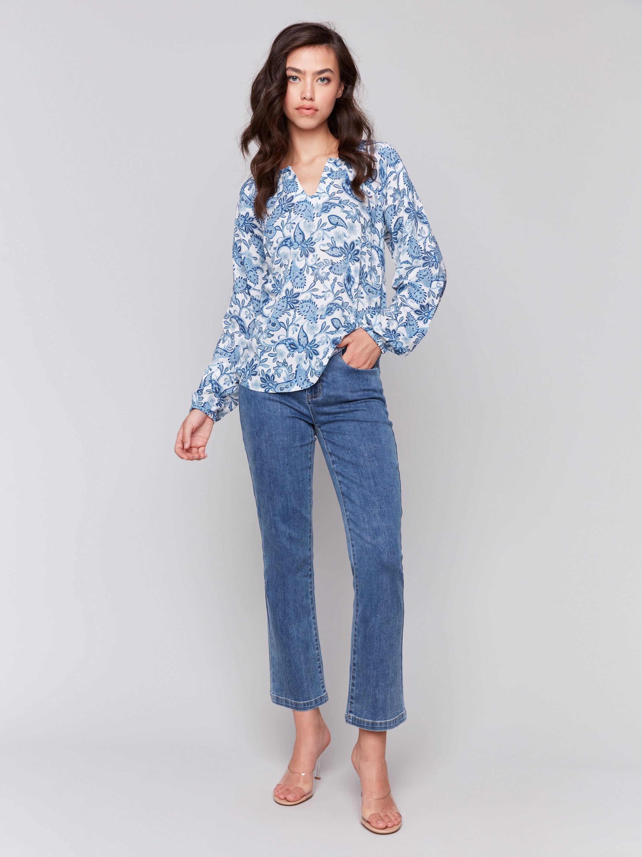 Blouse featuring twisted detail at neck in abstract azure pattern by Charlie B.