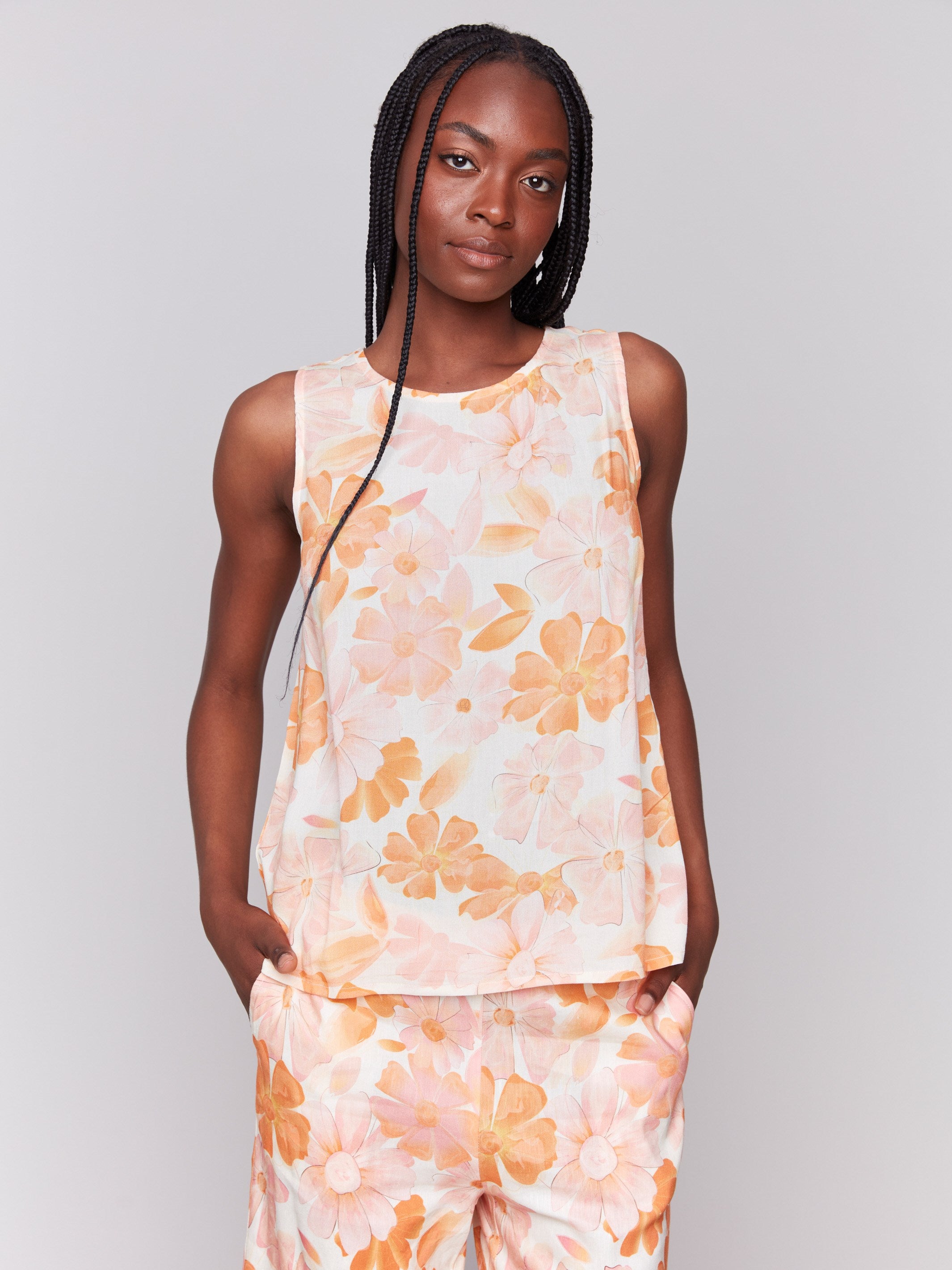 Stylish sleeveless design with floral accents by Charlie B.