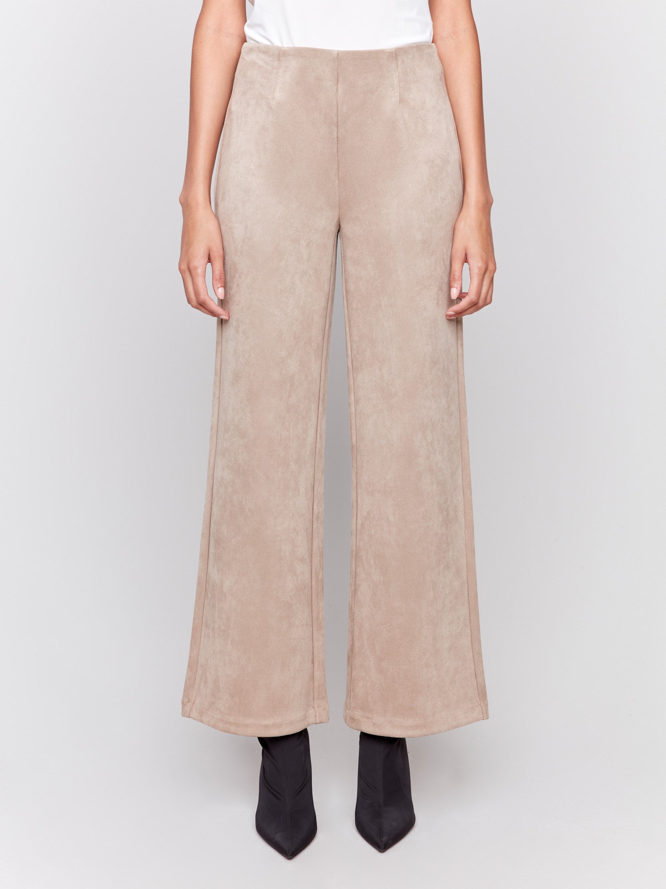 Natural beige faux suede flare pants with a pull-on style, featuring two back welt pockets by Charlie B.