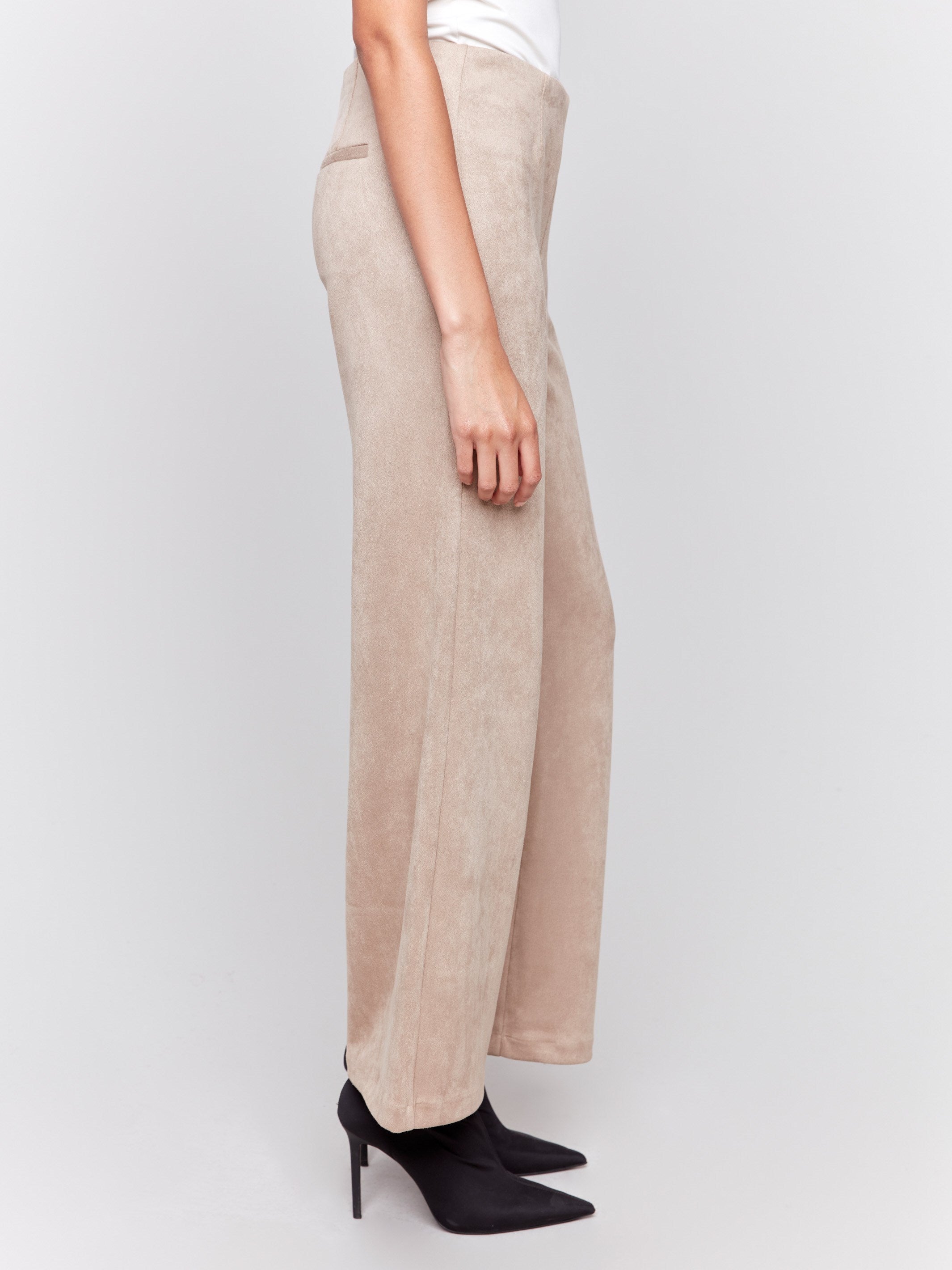 Natural beige faux suede flare pants with a pull-on style, featuring two back welt pockets by Charlie B.