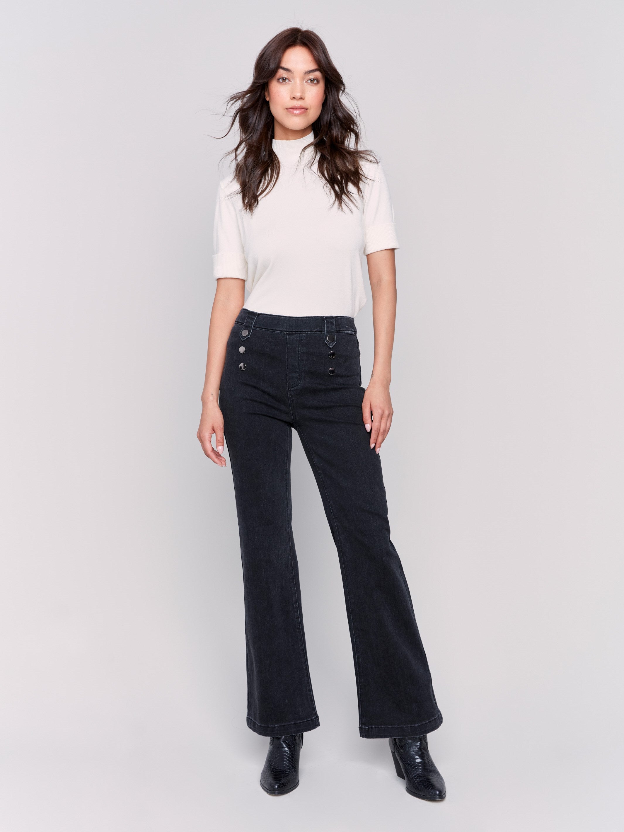 Charcoal black pull-on flare jeans featuring front button details, regular rise, and back pockets by Charlie B.