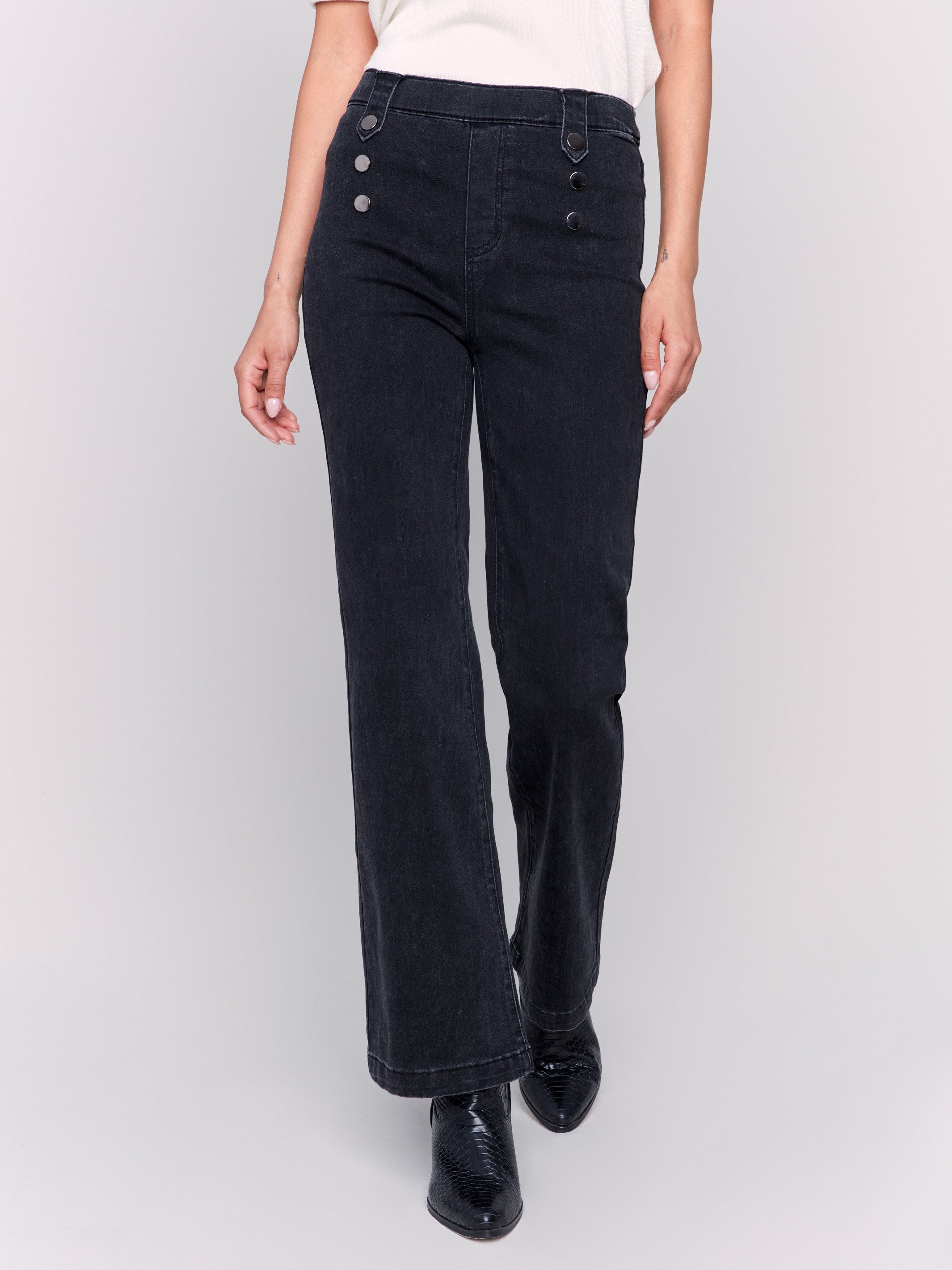 Charcoal black pull-on flare jeans featuring front button details, regular rise, and back pockets by Charlie B.