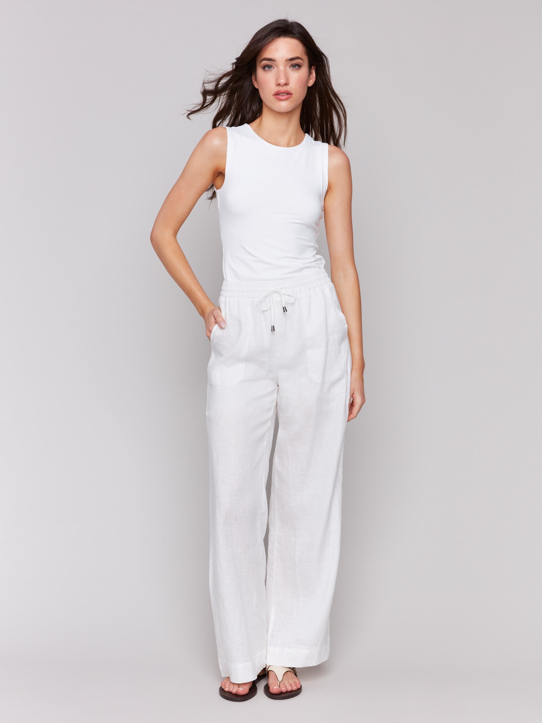 White pants with a wide leg fit and utility pockets by Charlie B.