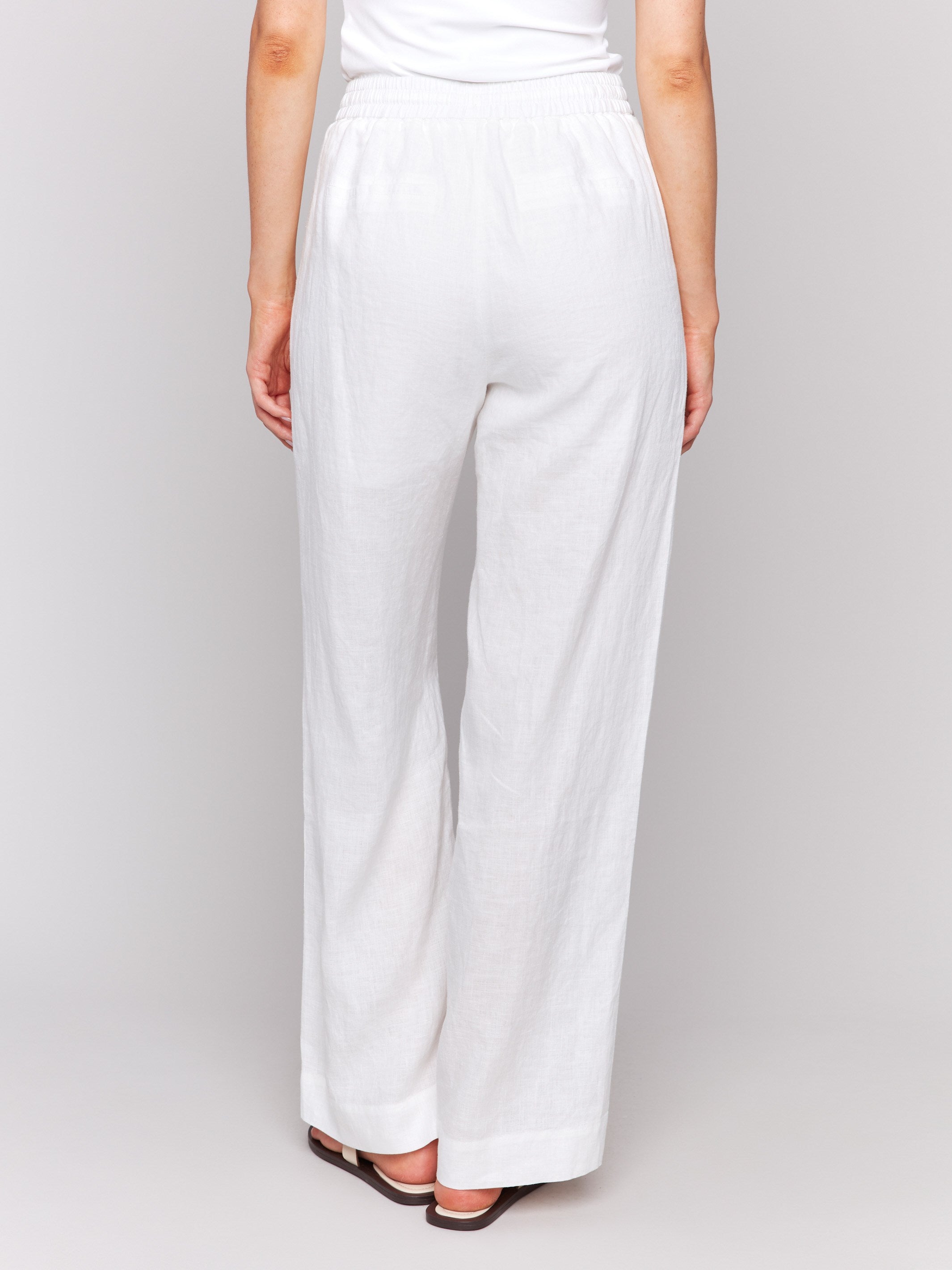 Stylish white pants designed with utility pockets by Charlie B.