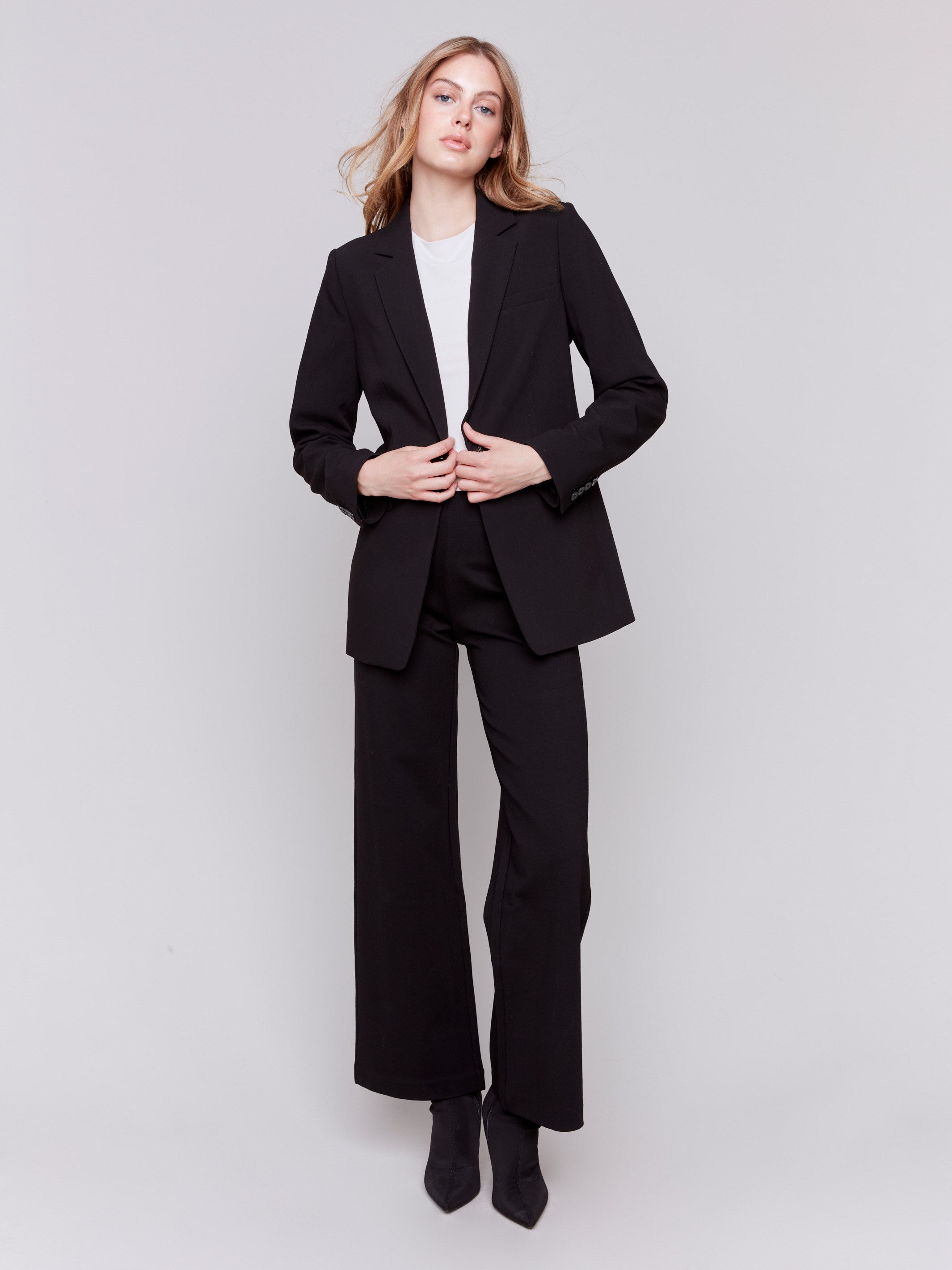 Black flared pants with pull-on style and elastic waistband by Charlie B.