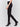 Black slim-leg pants with a regular rise, featuring a slit detail and an elastic waistband by Charlie B.