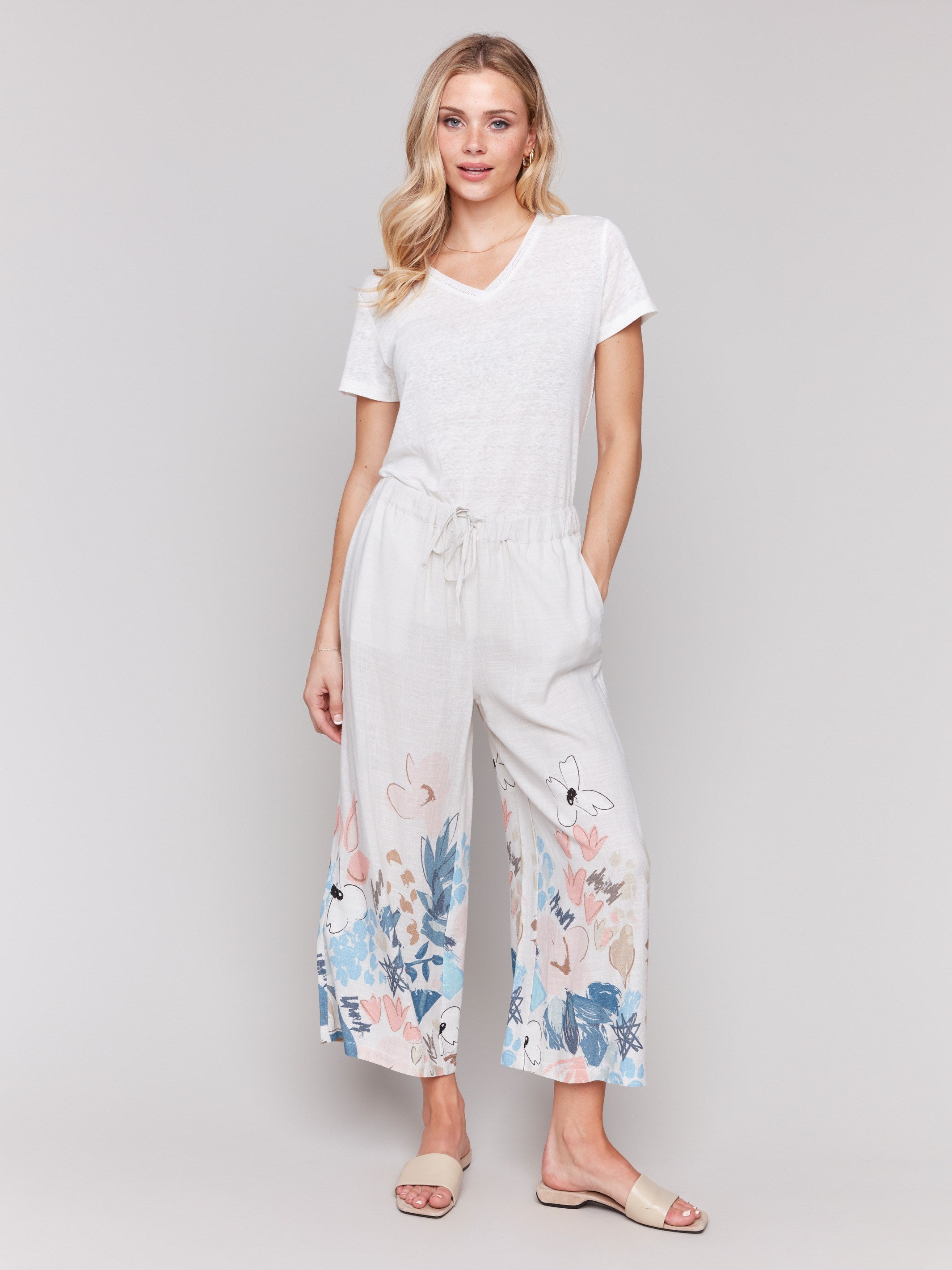 Linen blend pants with a wide leg fit and colorful floral print by Charlie B.