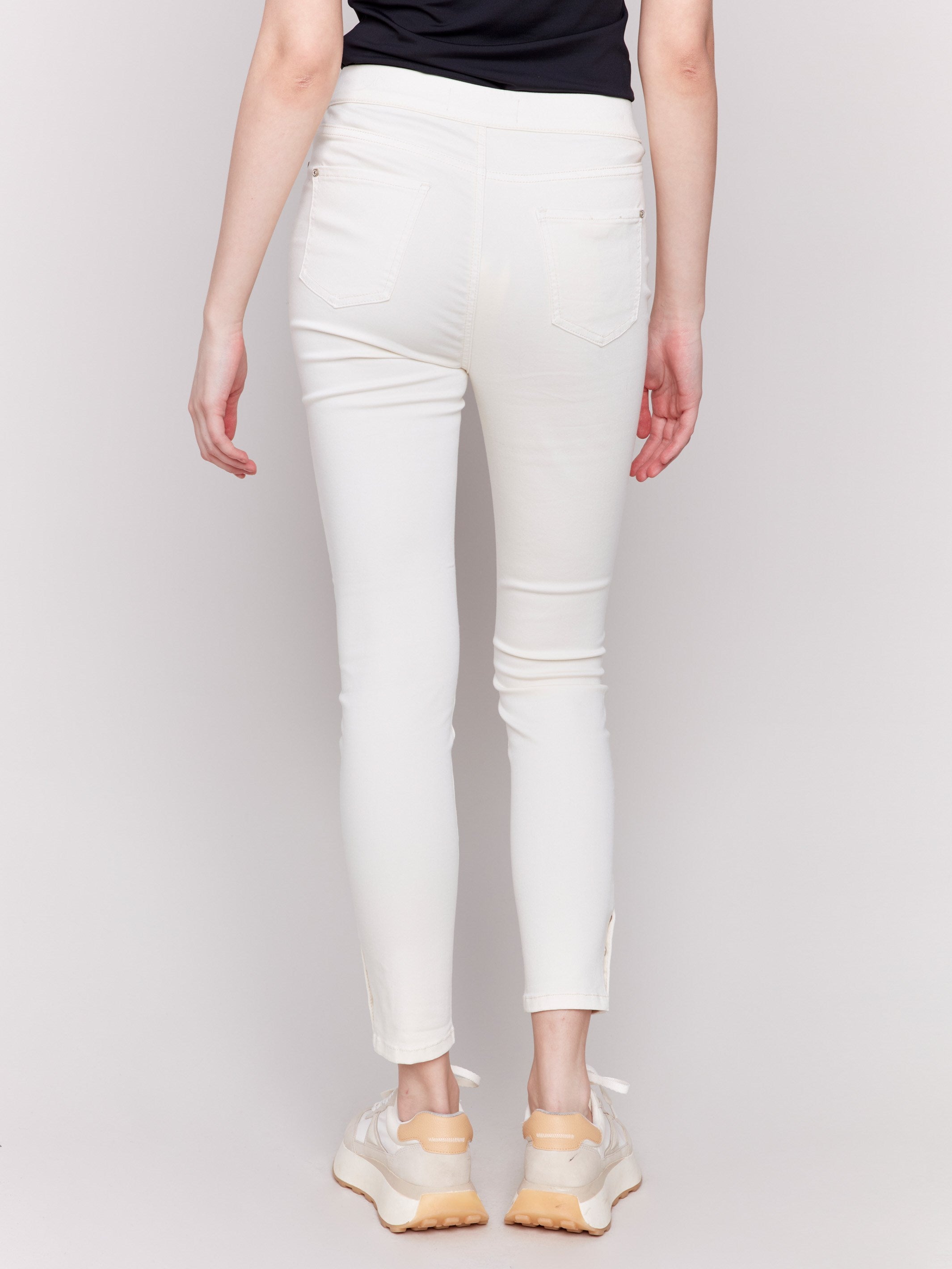 Pull-on twill pants in natural color with snap button hem, slim leg, and regular rise by Charlie B.