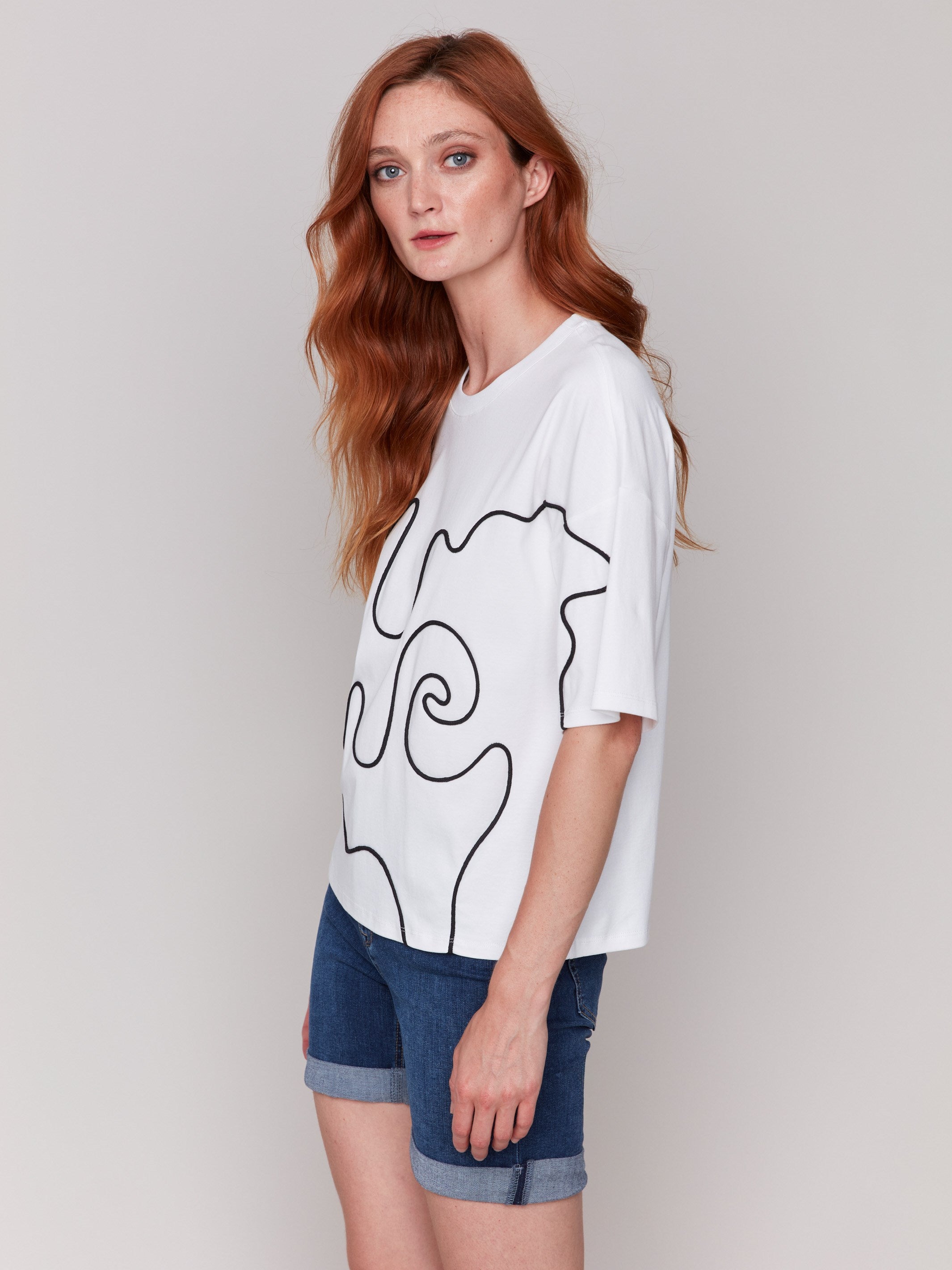 Short-sleeved white top with elegant soutache embellishments by Charlie B.