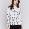 Black and cream reversible jacquard mock neck sweater with geometric patterns, featuring long sleeves by Charlie B.