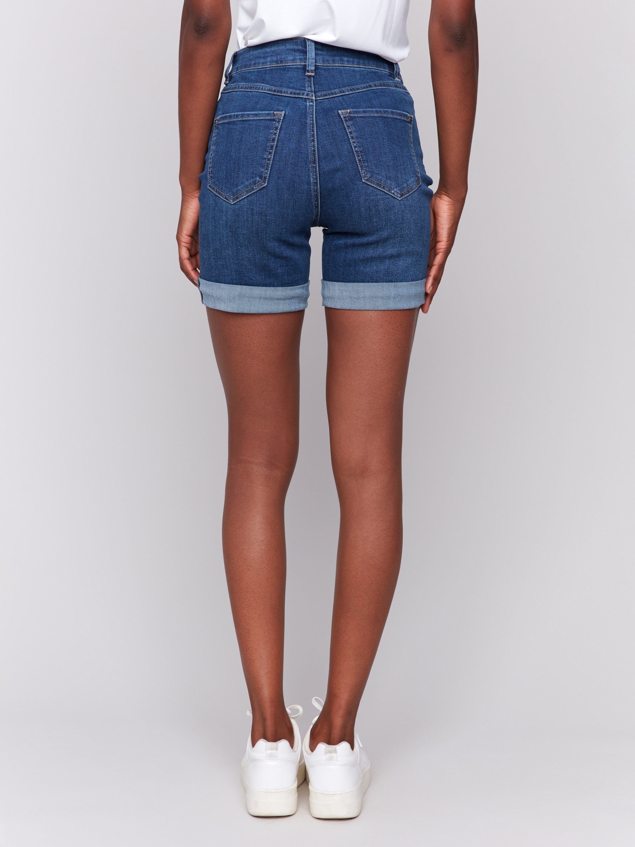 Rolled cuff design on indigo denim shorts adds a stylish touch by Charlie B.