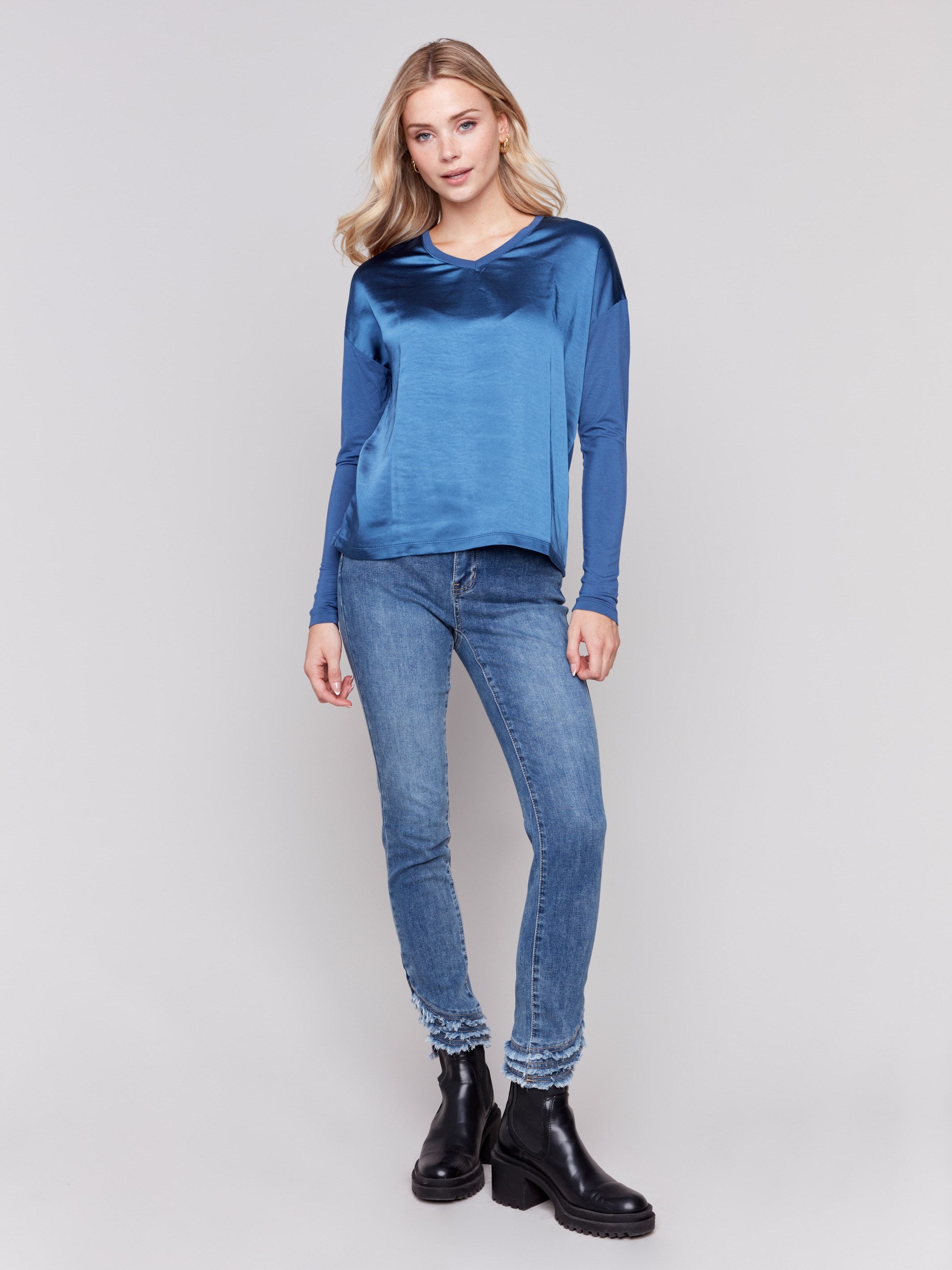 Blue satin and jersey top featuring V-neck design and long sleeves by Charlie B.