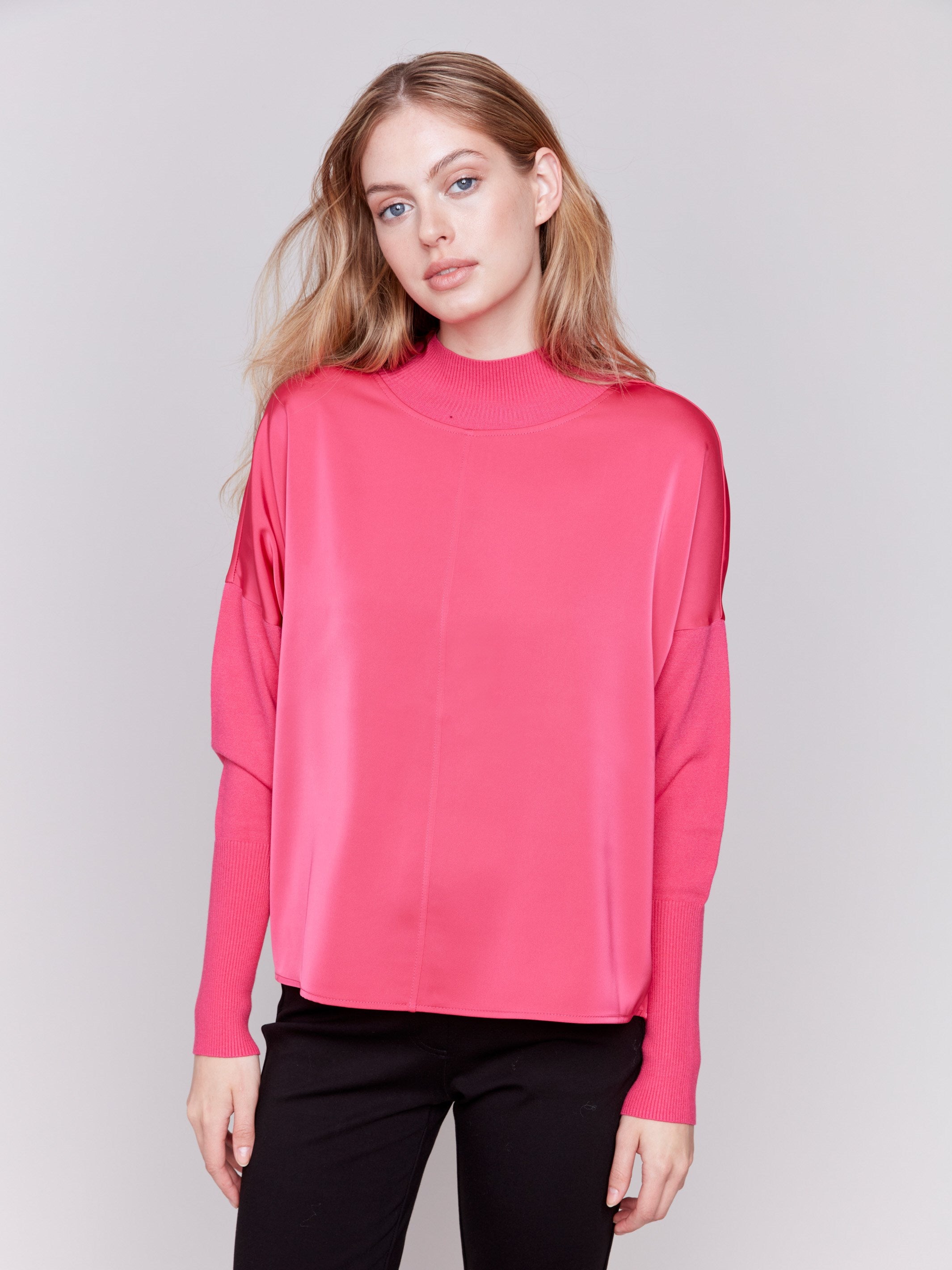 Magenta pink satin-knit top with a mock neck and front seam detail, featuring long sleeves and ribbed cuffs by Charlie B.