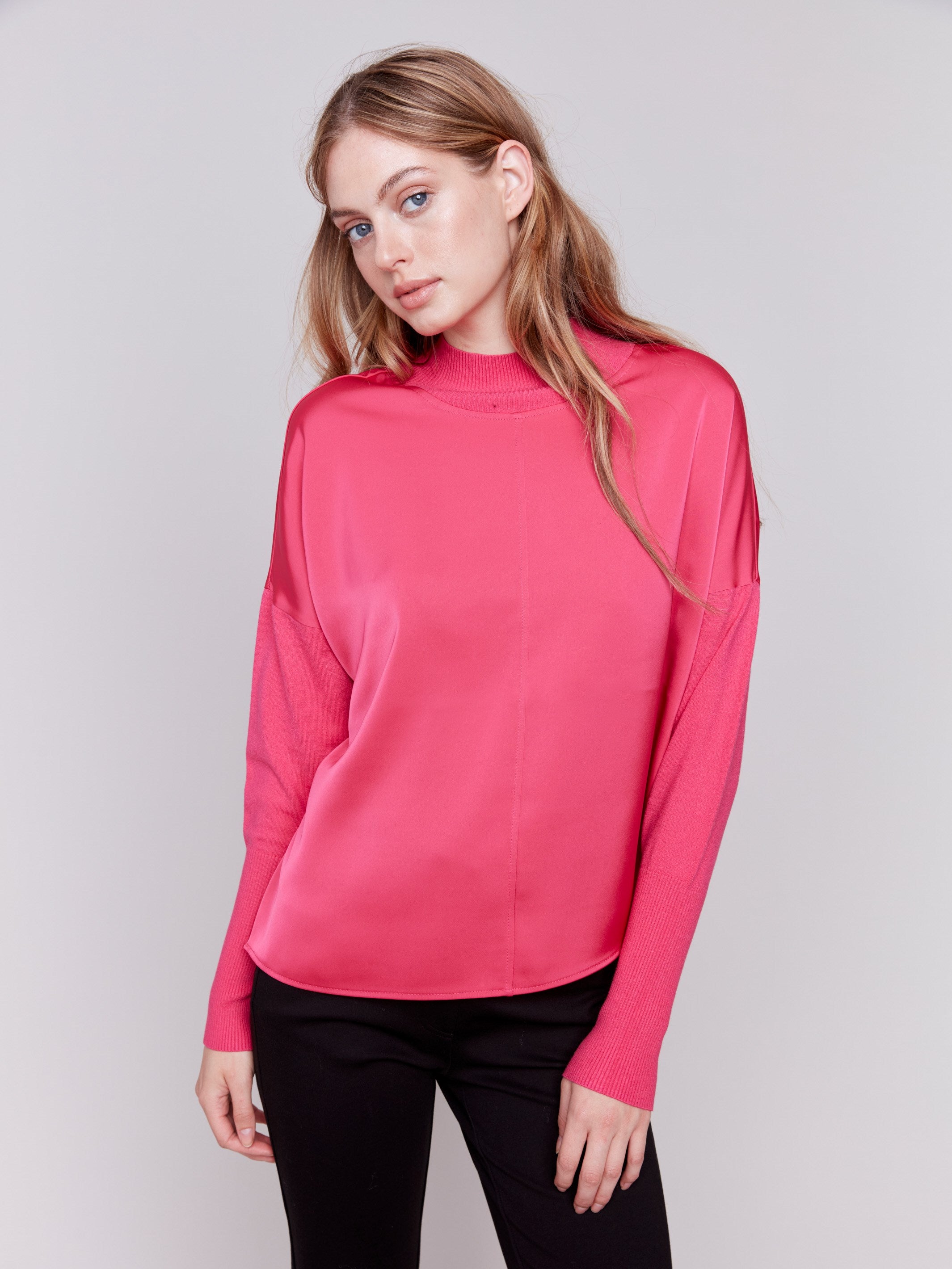 Magenta pink satin-knit top with a mock neck and front seam detail, featuring long sleeves and ribbed cuffs by Charlie B.