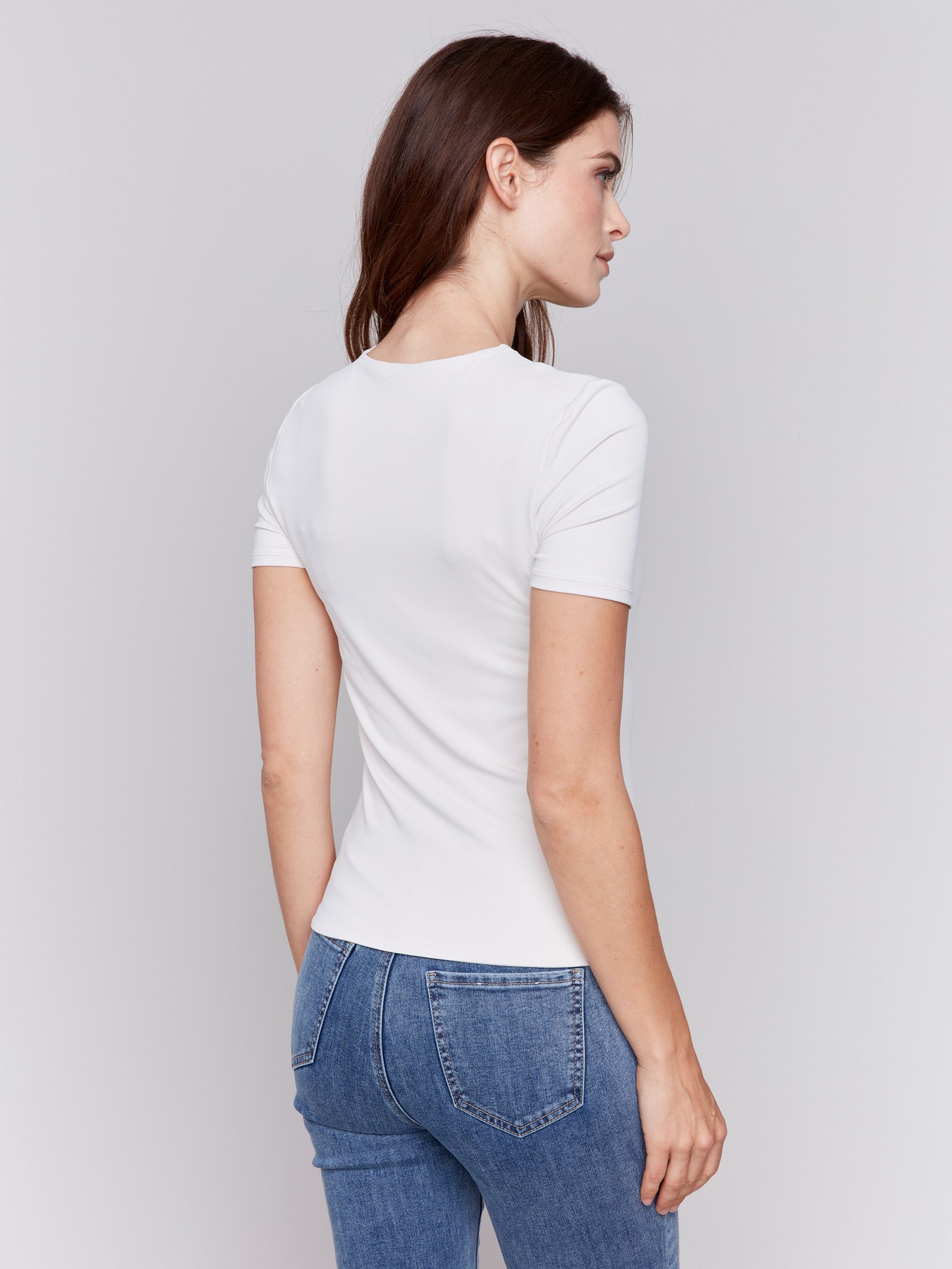 Natural white short-sleeved super stretch top with a crew neckline, showcasing a slim fit design by Charlie B.