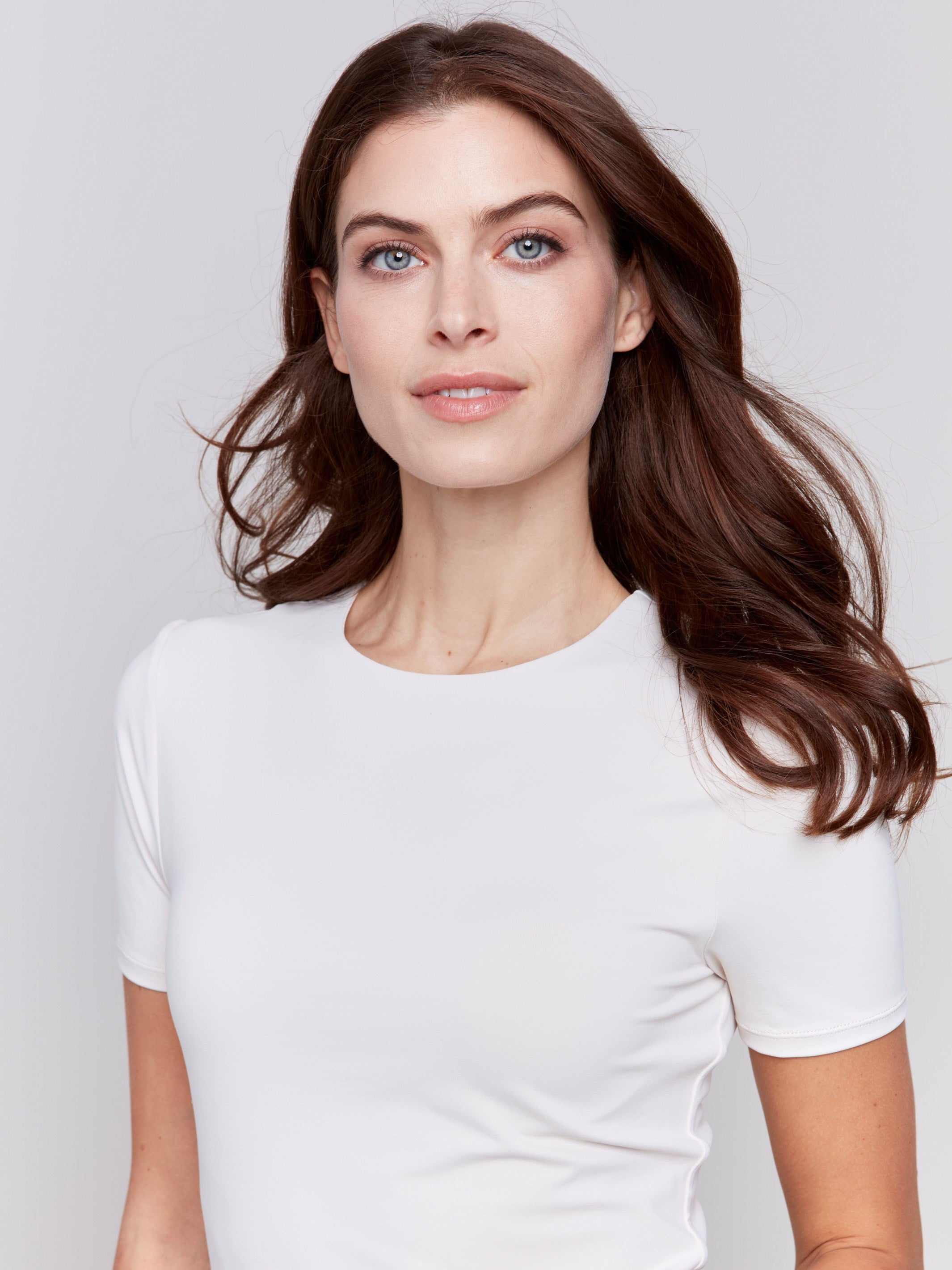 Natural white short-sleeved super stretch top with a crew neckline, showcasing a slim fit design by Charlie B.